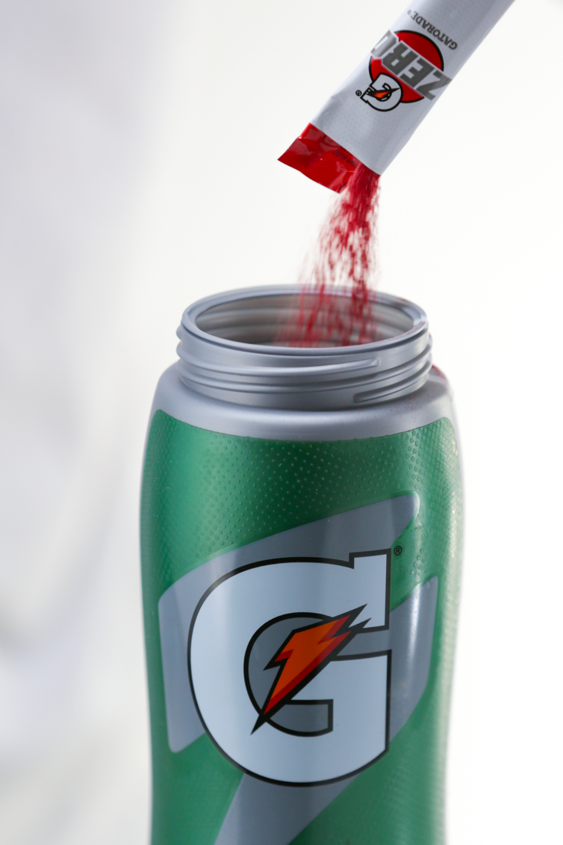 Gatorade zero fruit punch powder being poured into Gx bottle