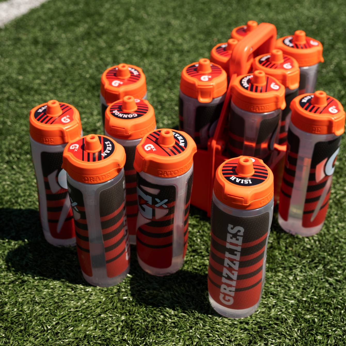 Social share image of custom team Gx bottles on a football field.