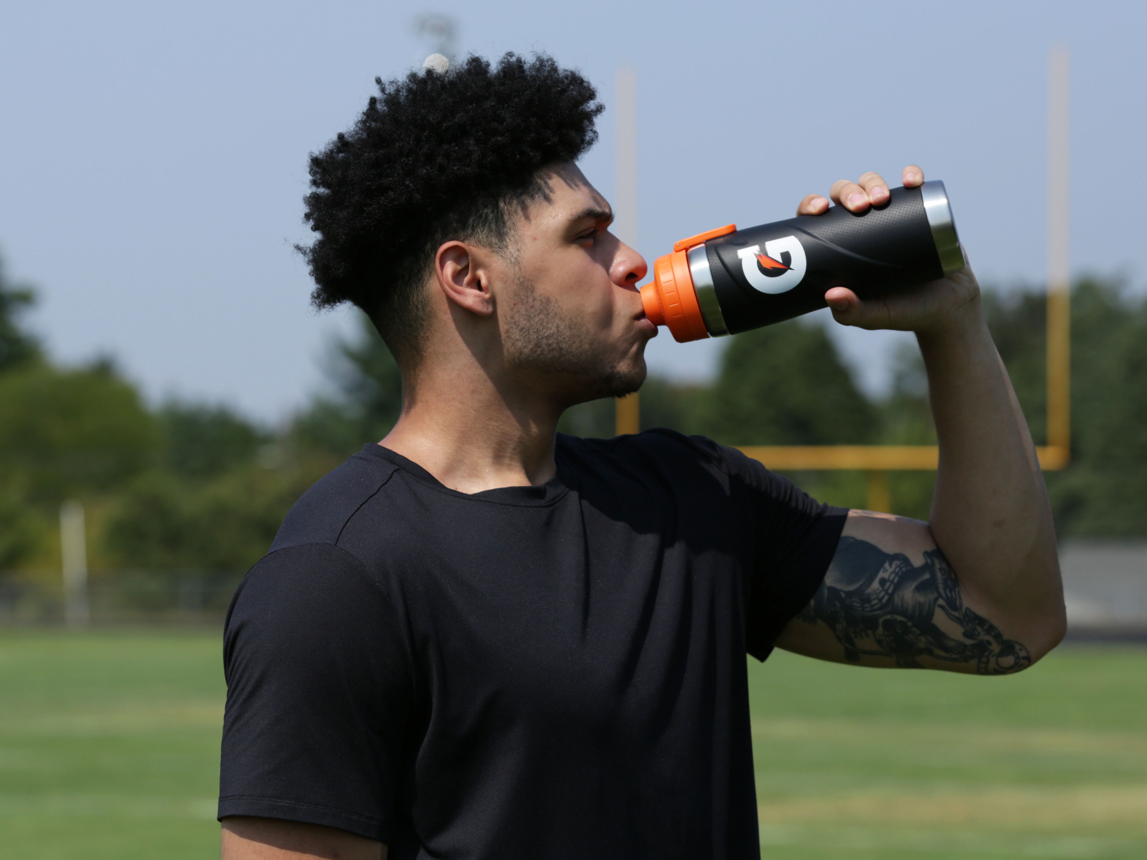 Athlete drinking from a Black Gx Stainless Steel Bottle