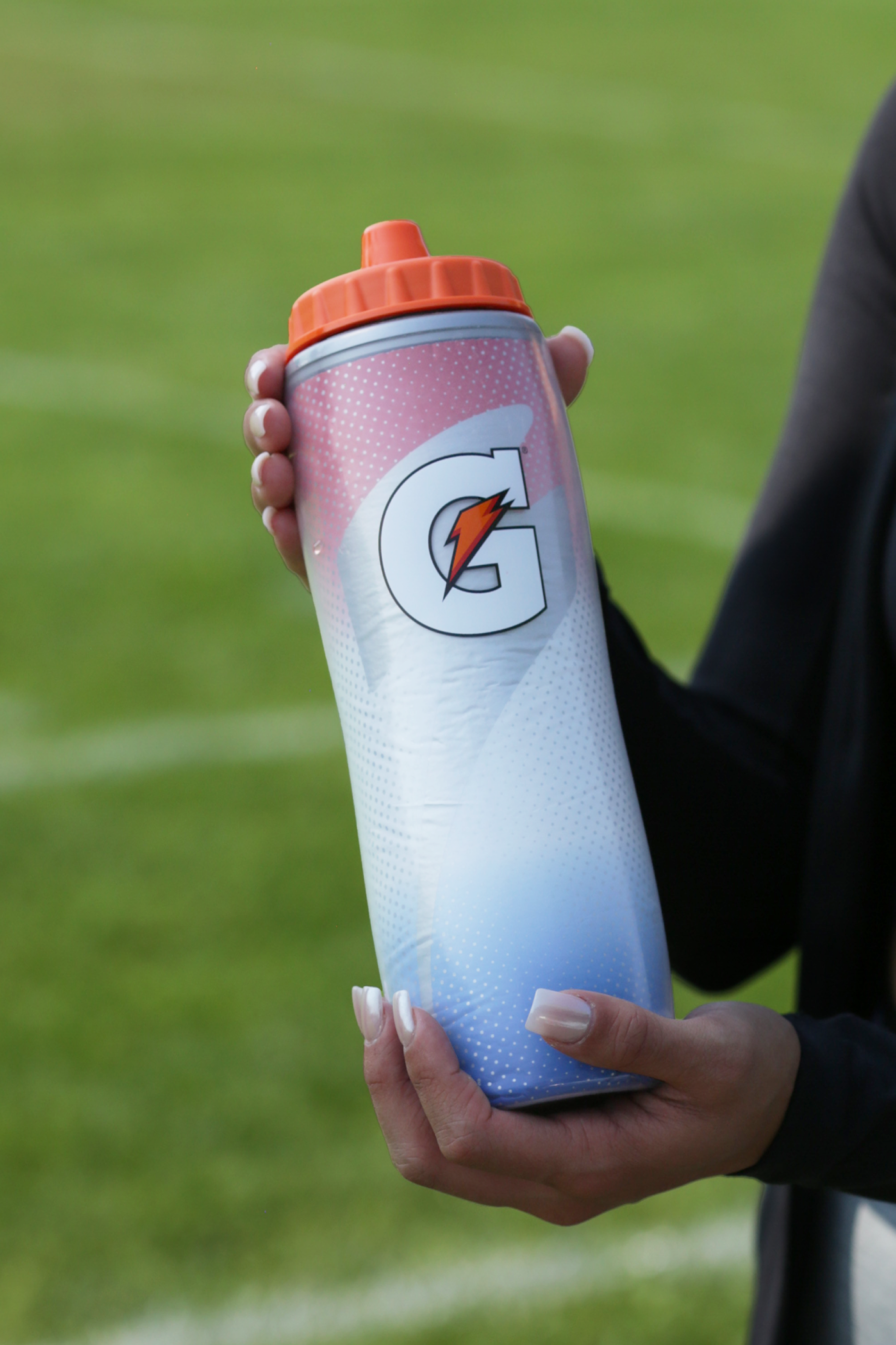 Athlete holding a Faded Flag Insulated Squeeze Bottle