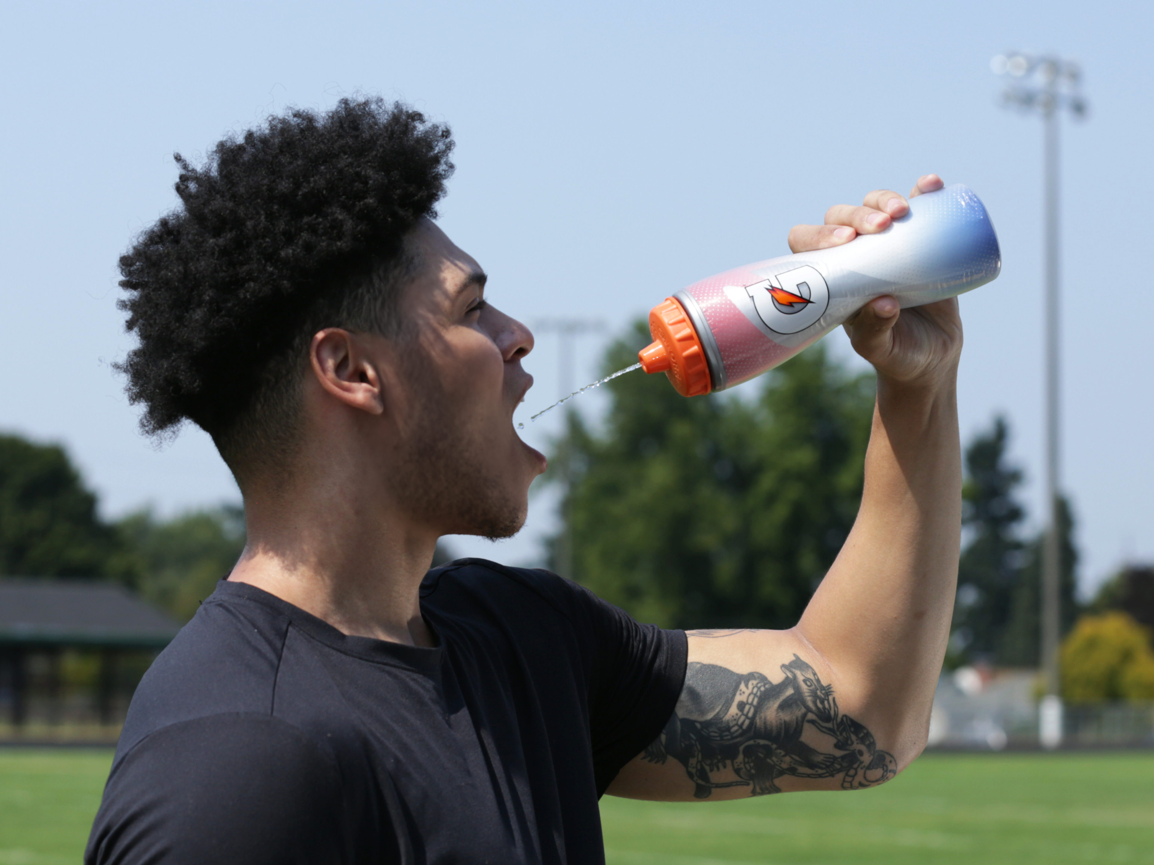 Athlete drinking Gatorade from a Faded Flag Insulated Squeeze Bottle