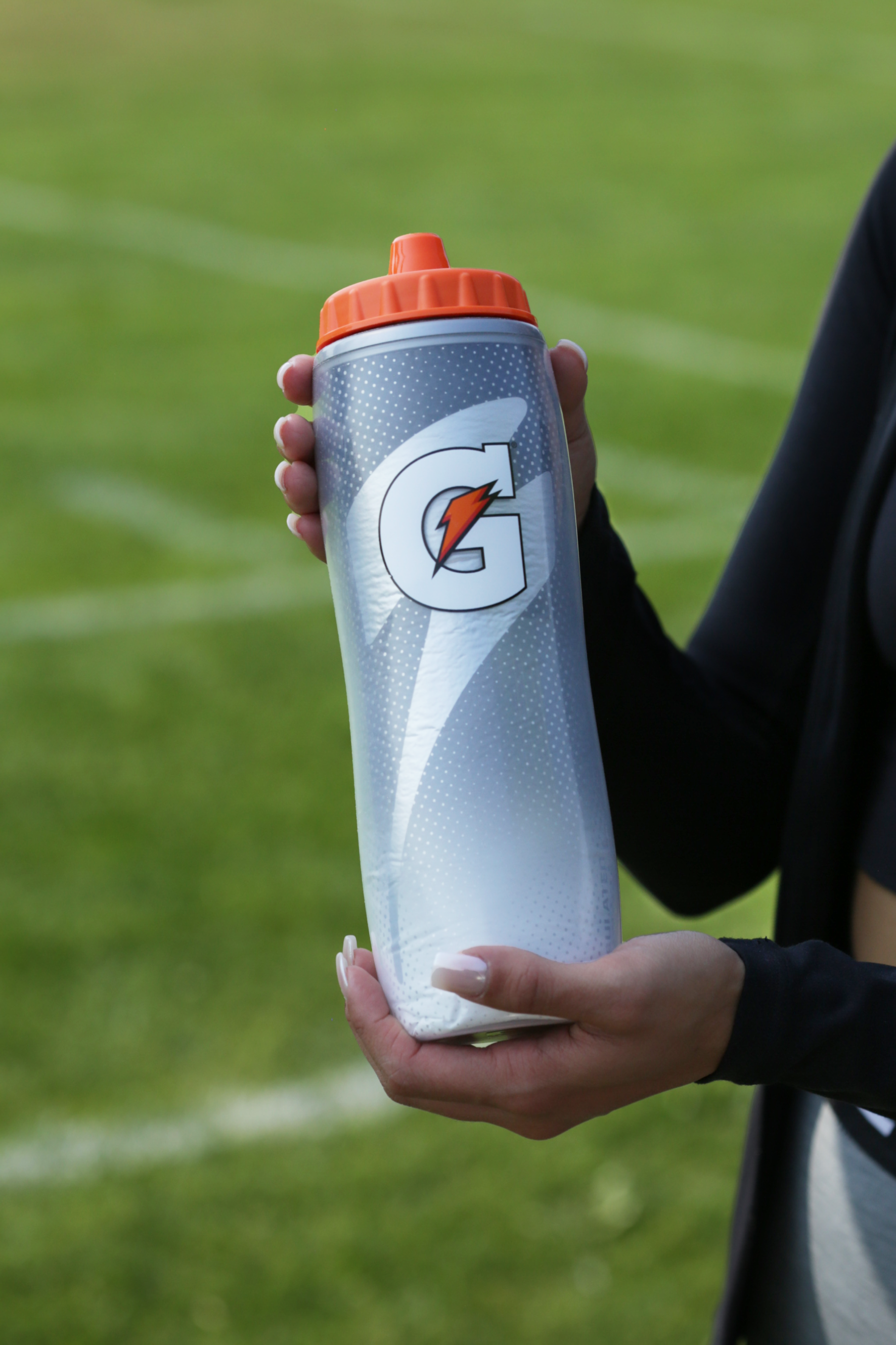Athlete holding a Light Shadow Insulated Squeeze Bottle