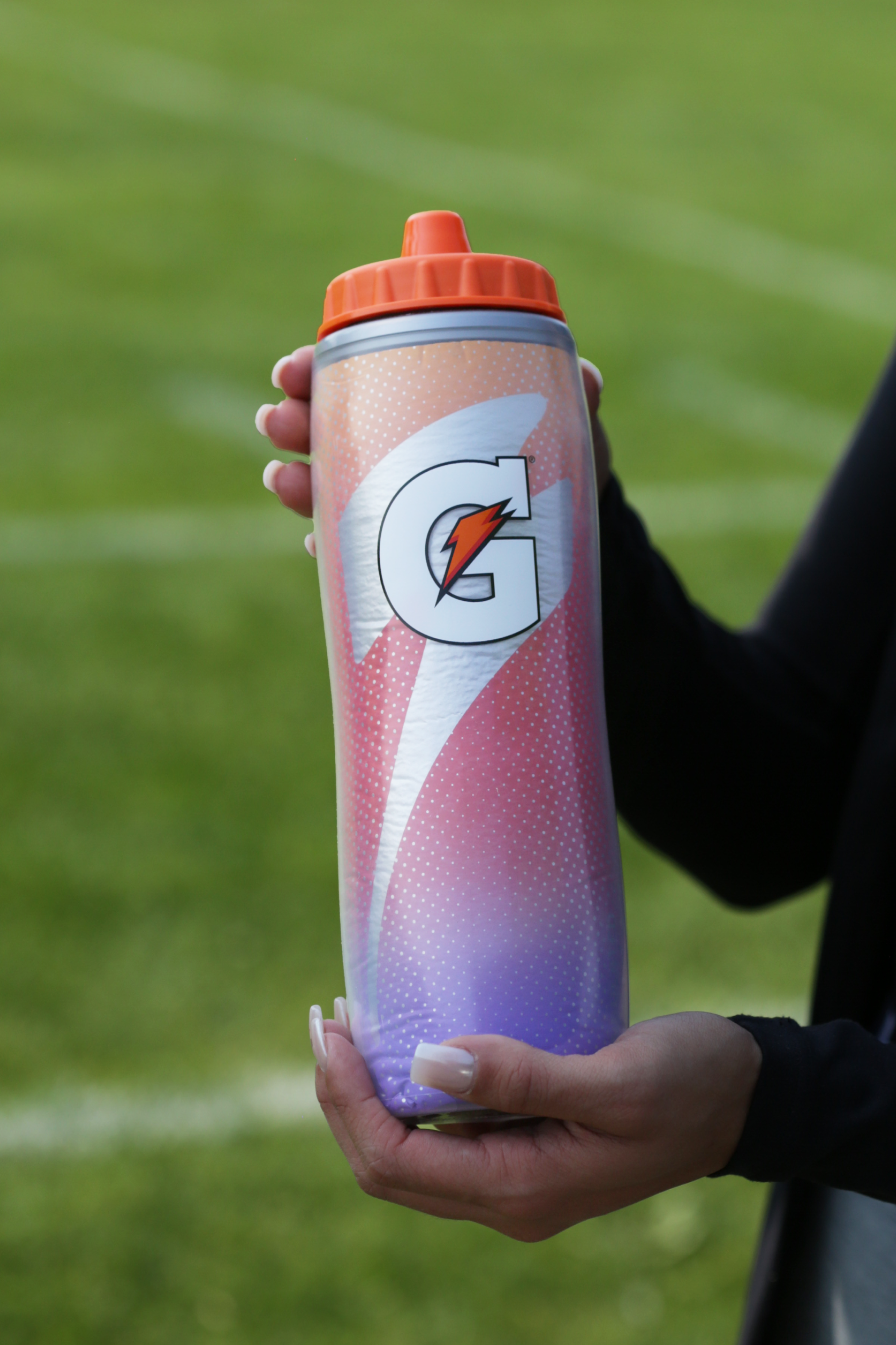 Athlete holding a Purple Flame Insulated Squeeze Bottle