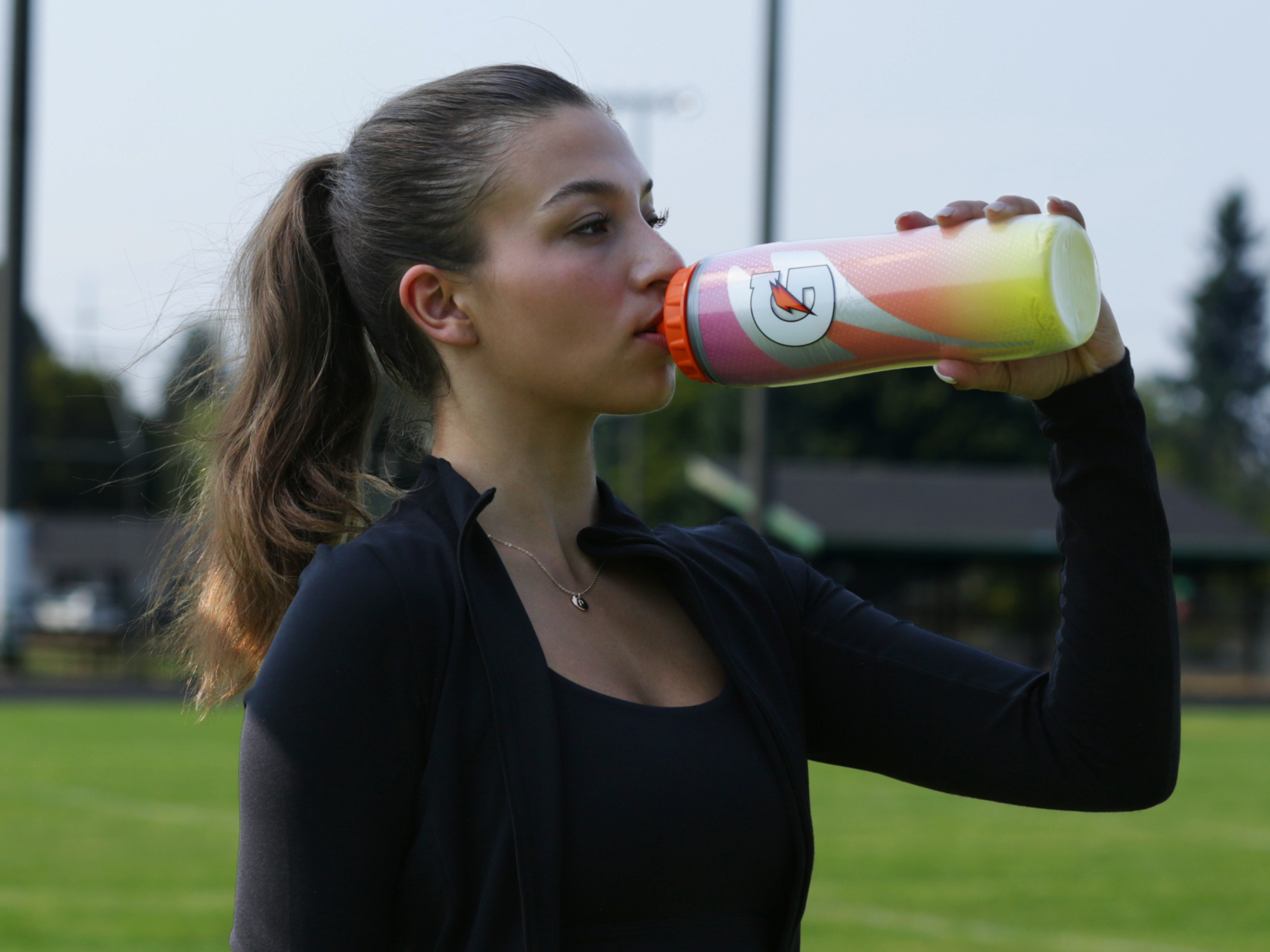 Athlete drinking from a Sweet Fire Insulated Squeeze Bottle