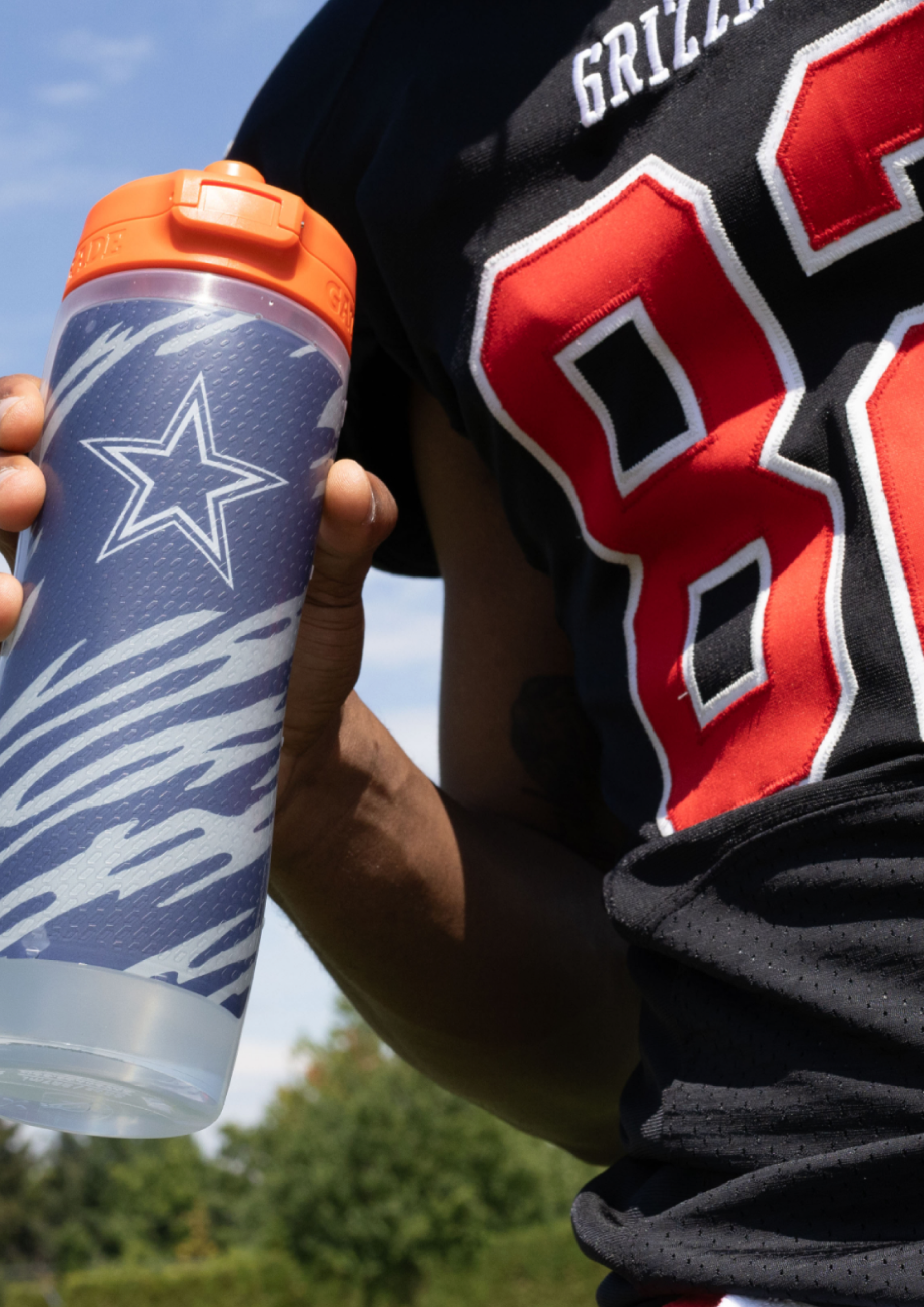 Athlete holding NFL bottle