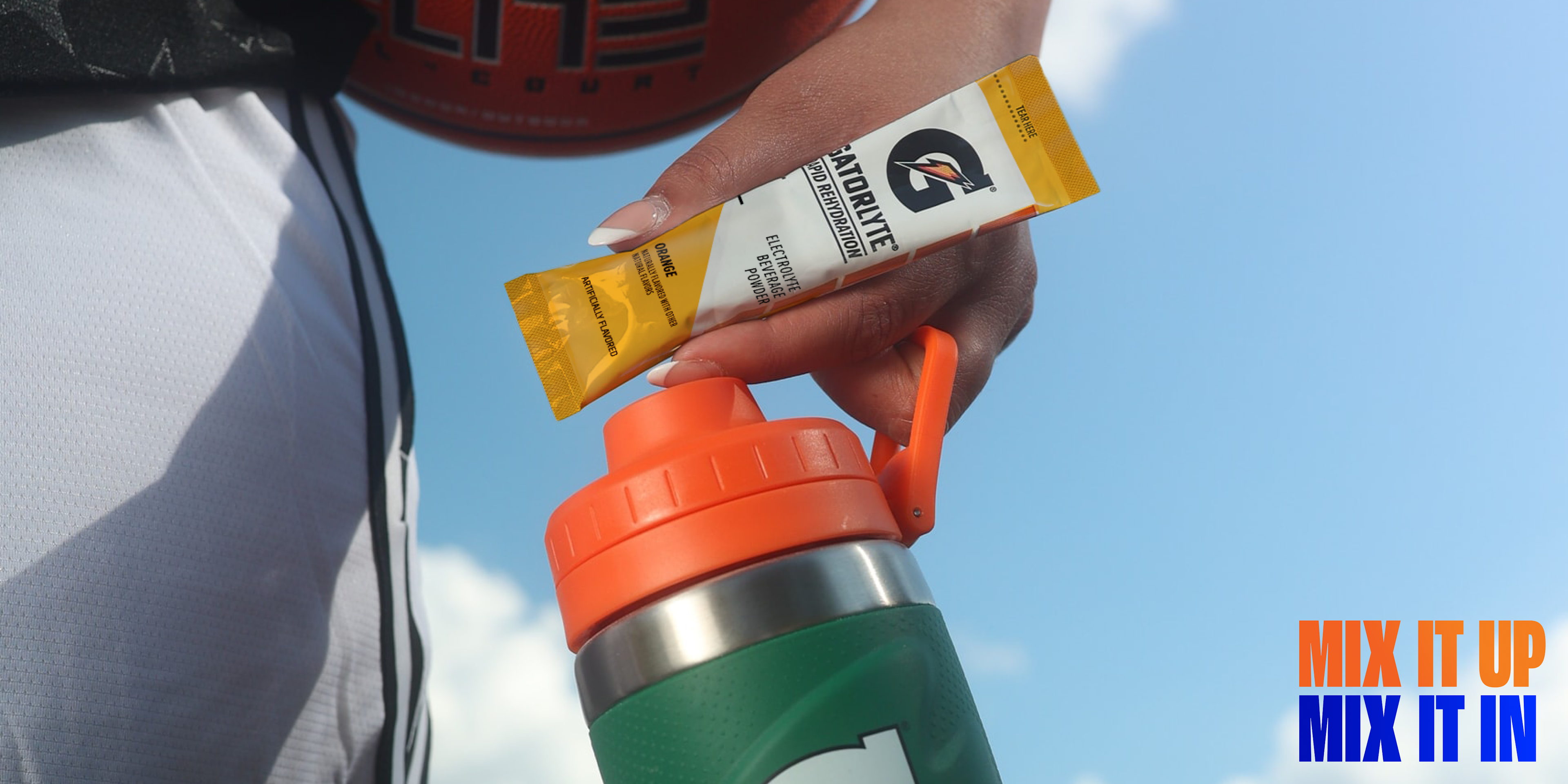 Athlete with Gatorlyte single serve orange packet and stainless steel bottle