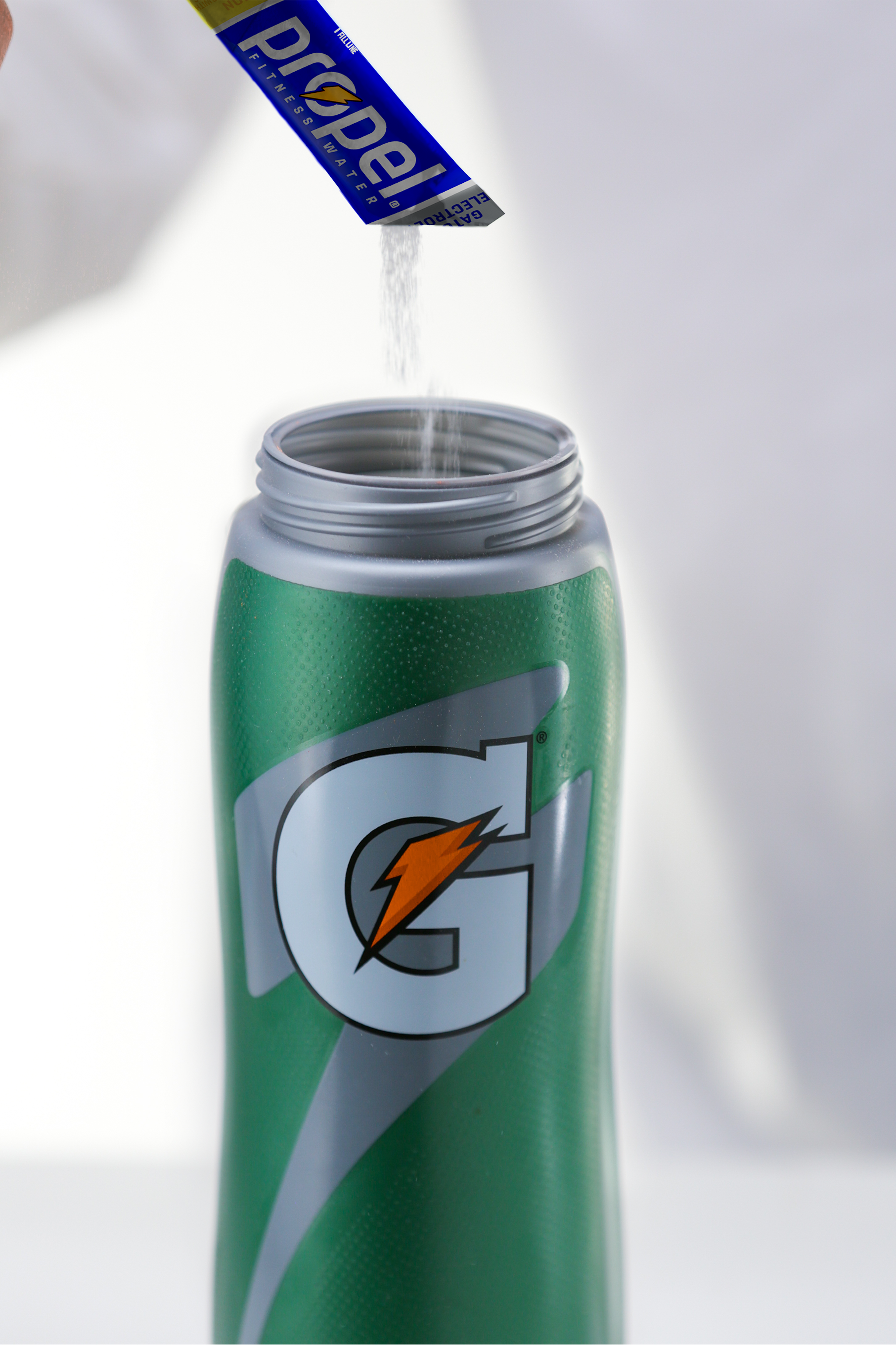 Lemon Propel powder poured into Gatorade bottle