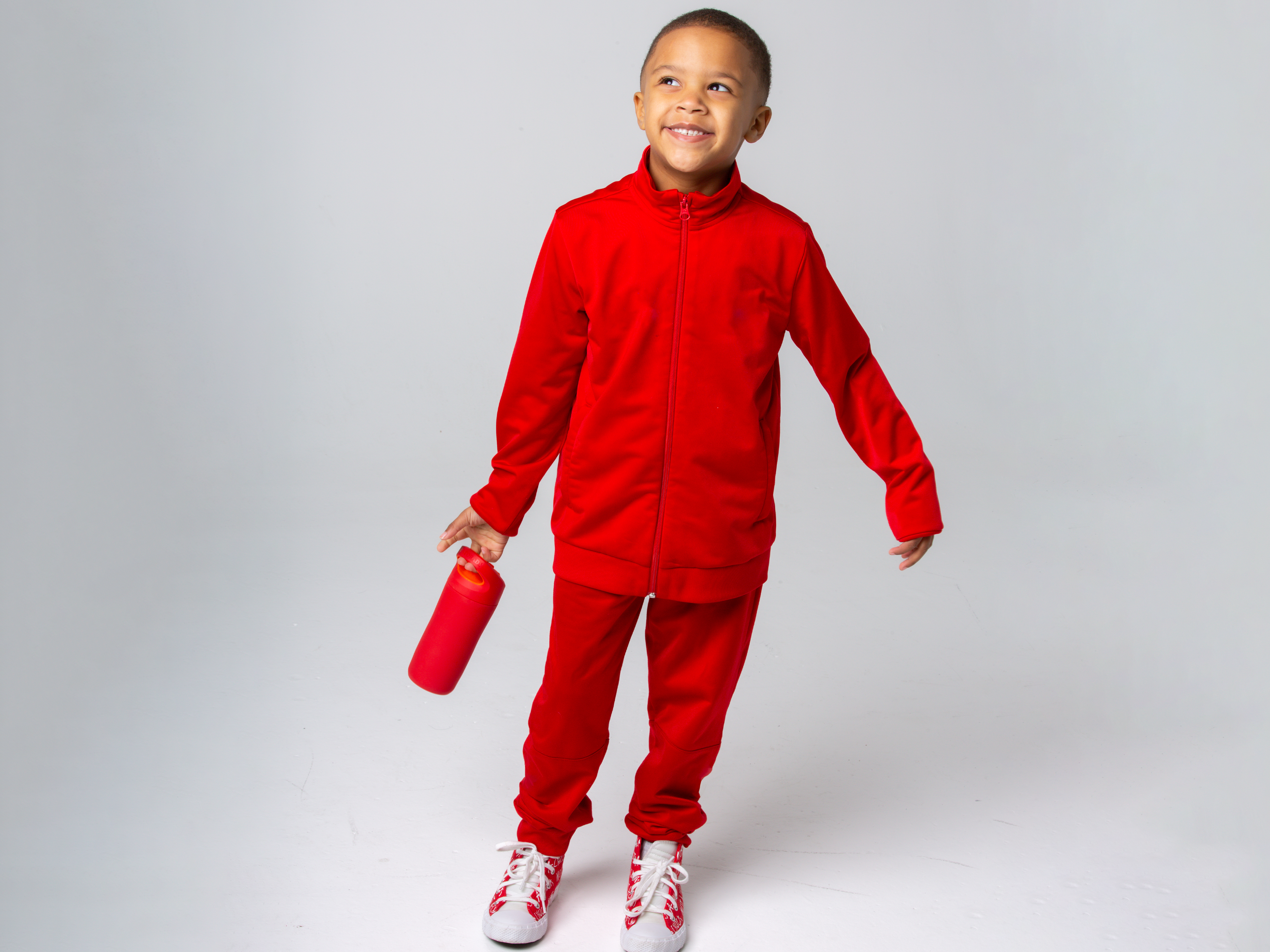 Young athlete with rookie bottle in red