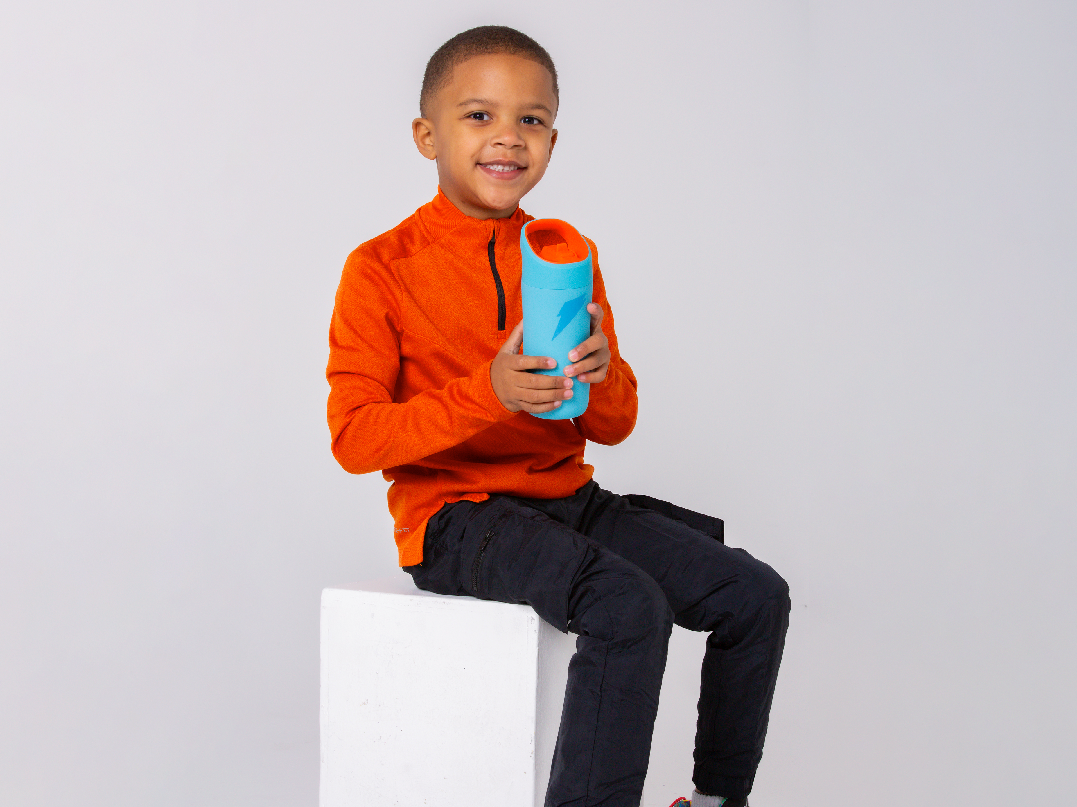 Young athlete with rookie bottle in blue