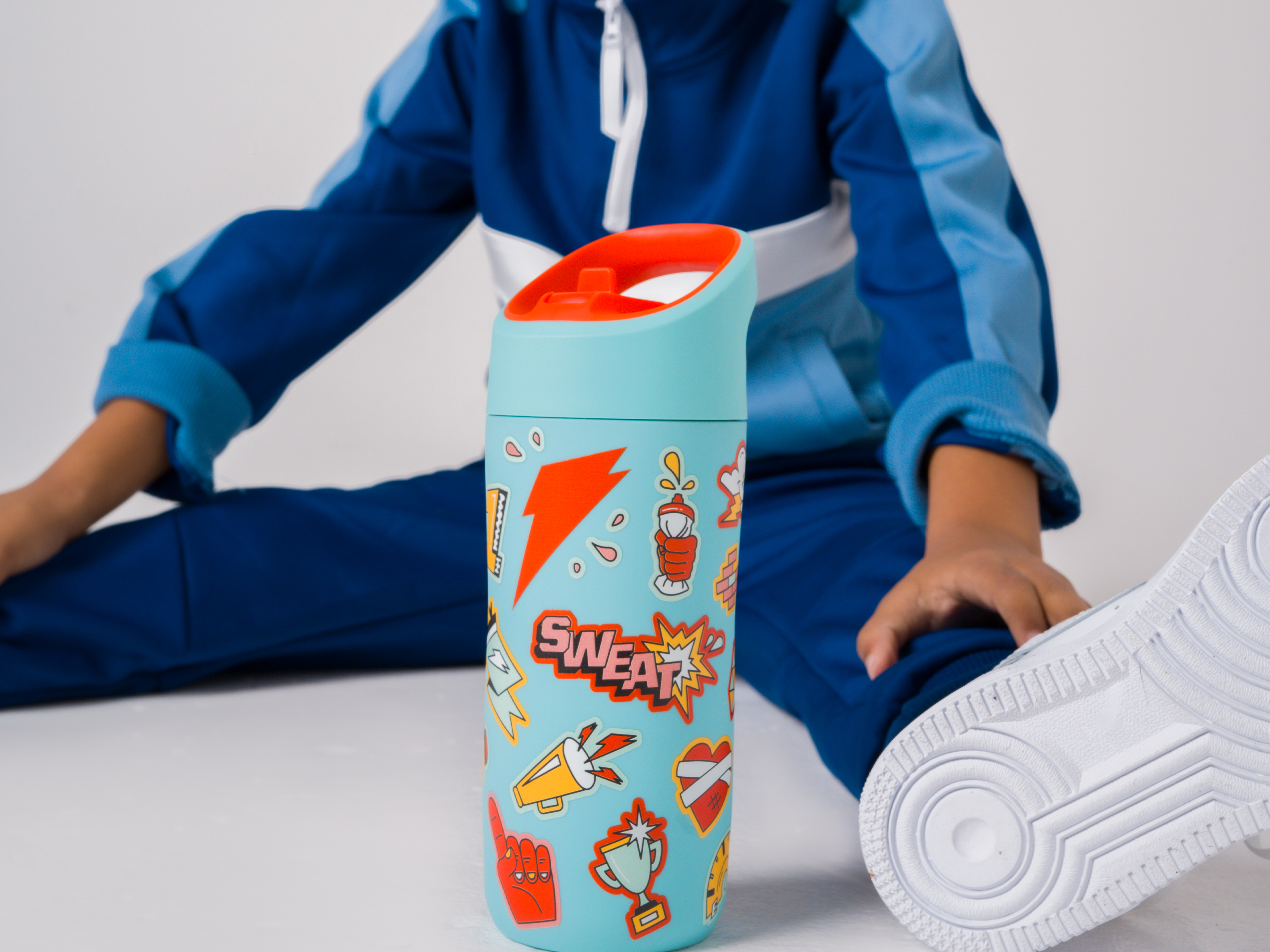 Young athlete with rookie bottle in blue with stickers