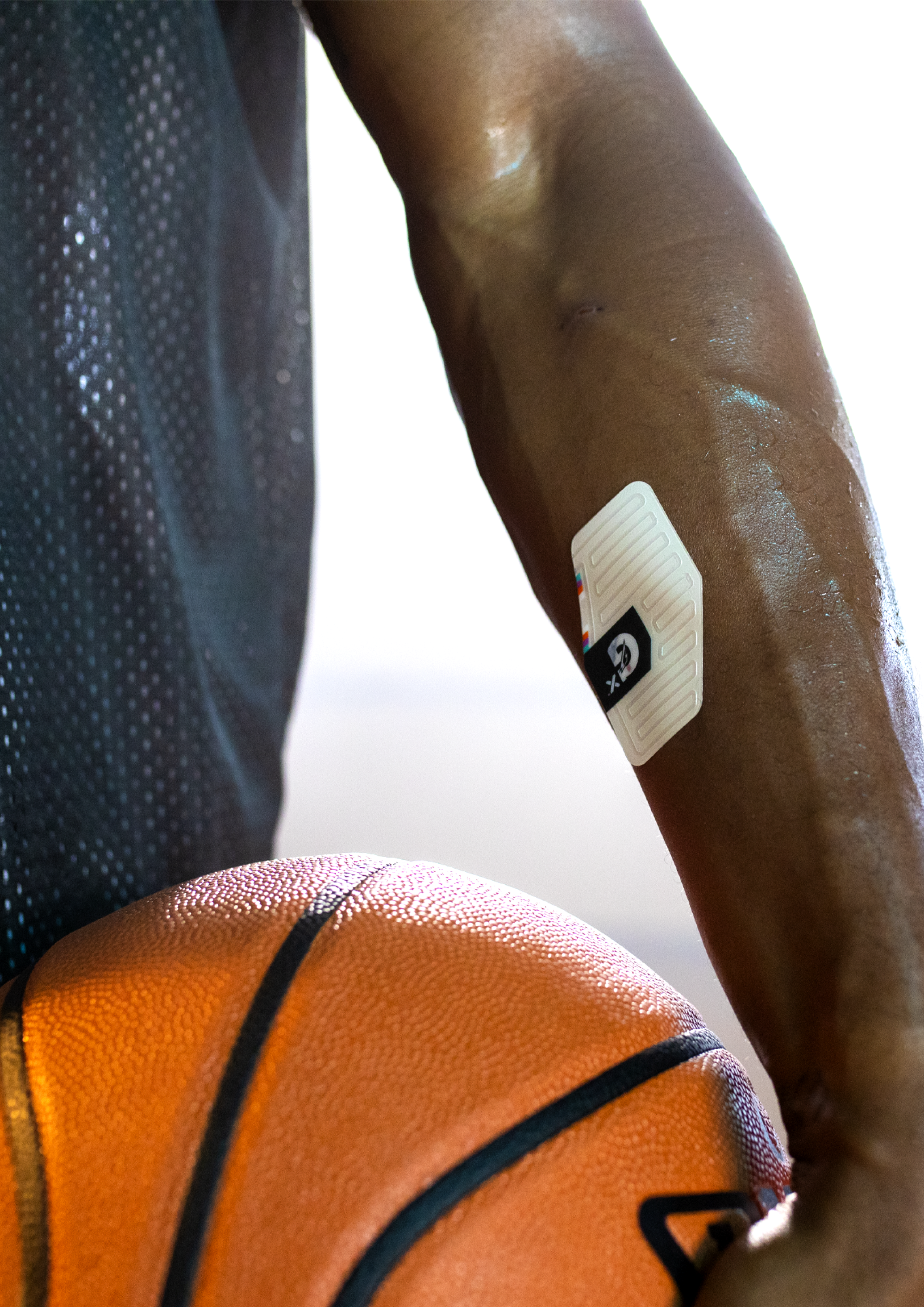 Athlete wearing sweat patch with basketball