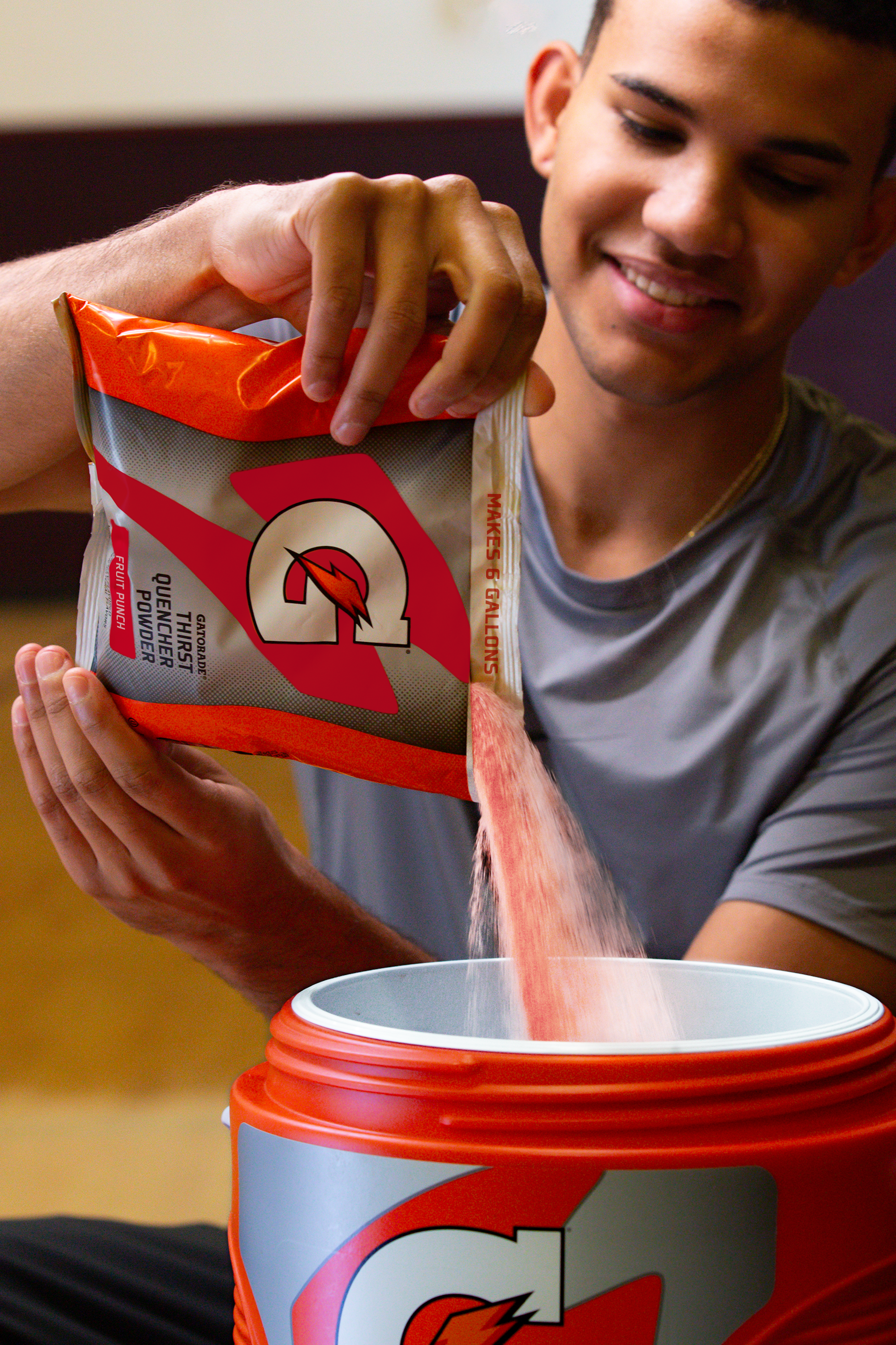 Gatorade Thirst Quencher 6 gallon bag of Fruit Punch powder being poured into cooler.