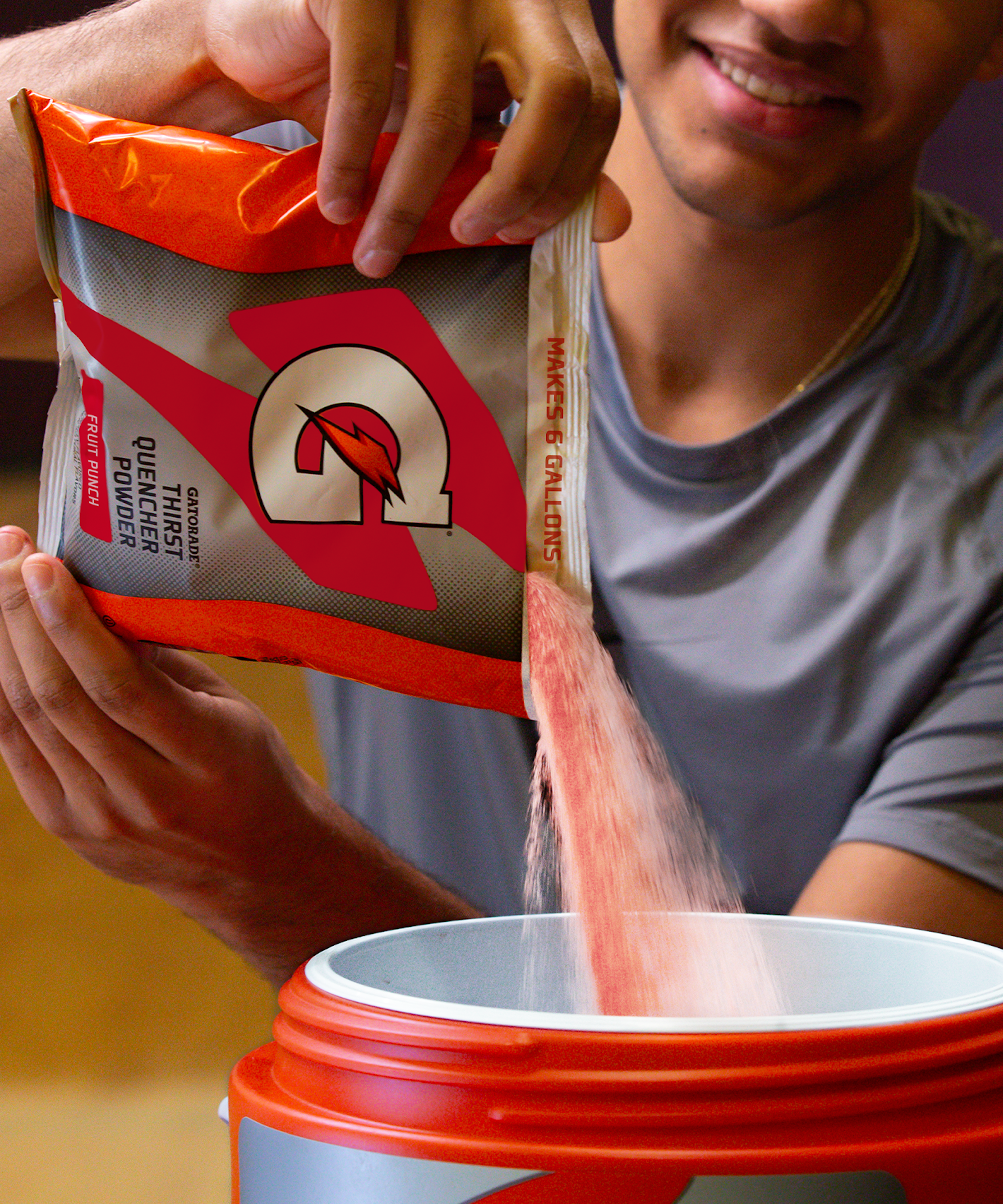 Gatorade Thirst Quencher 6 gallon bag of Fruit Punch powder being poured into cooler.