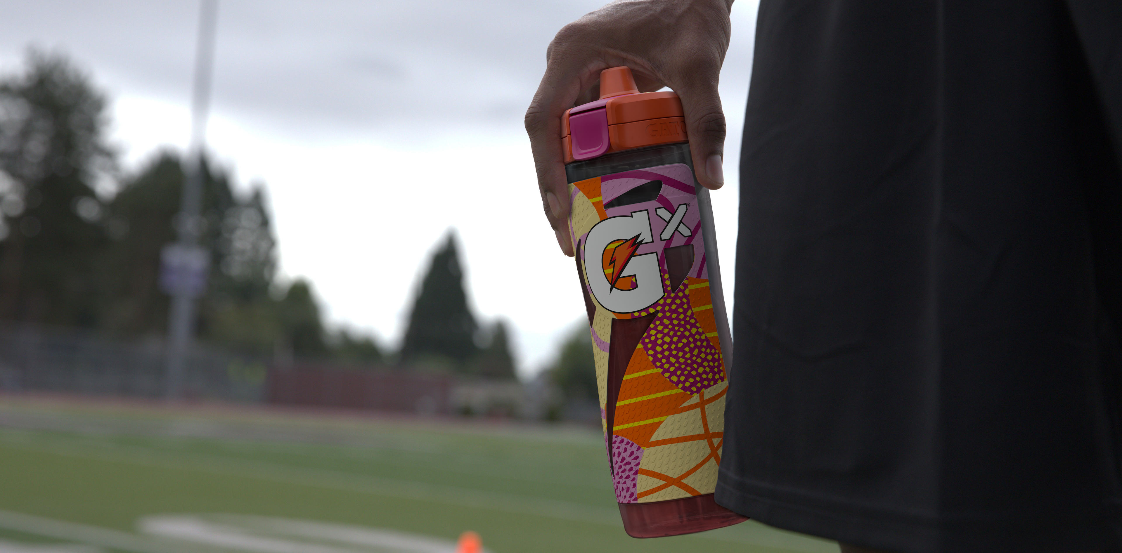 Athlete holding Orange Montage Gx Squeeze Bottle