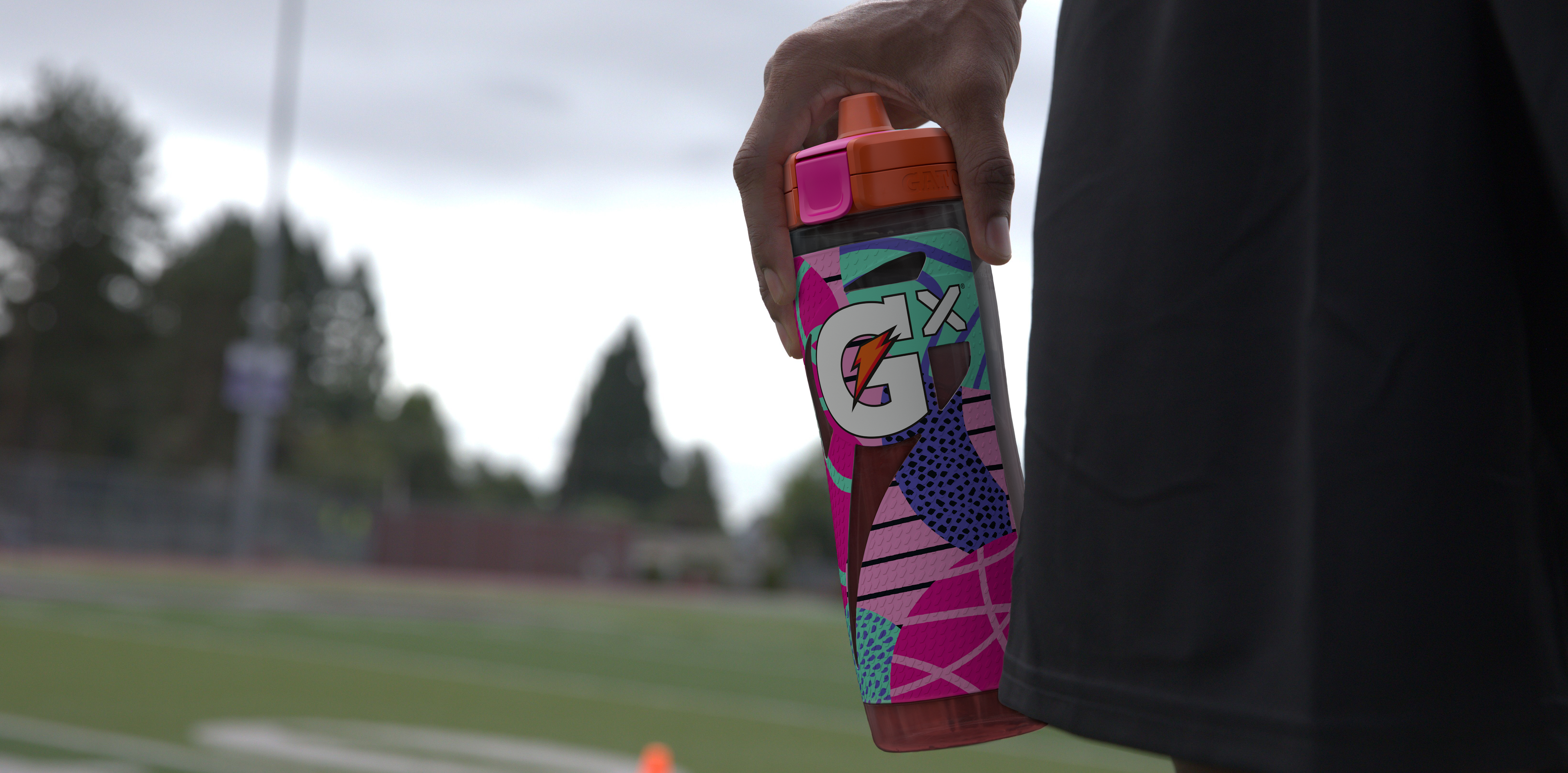 Athlete holding pink montage bottle