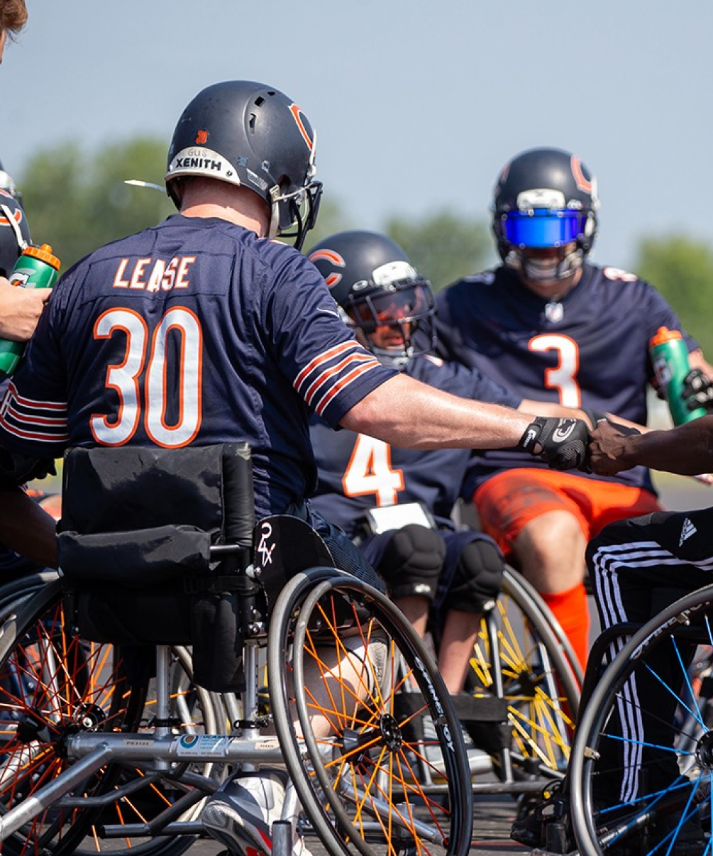 Athletes in wheelchairs playing football