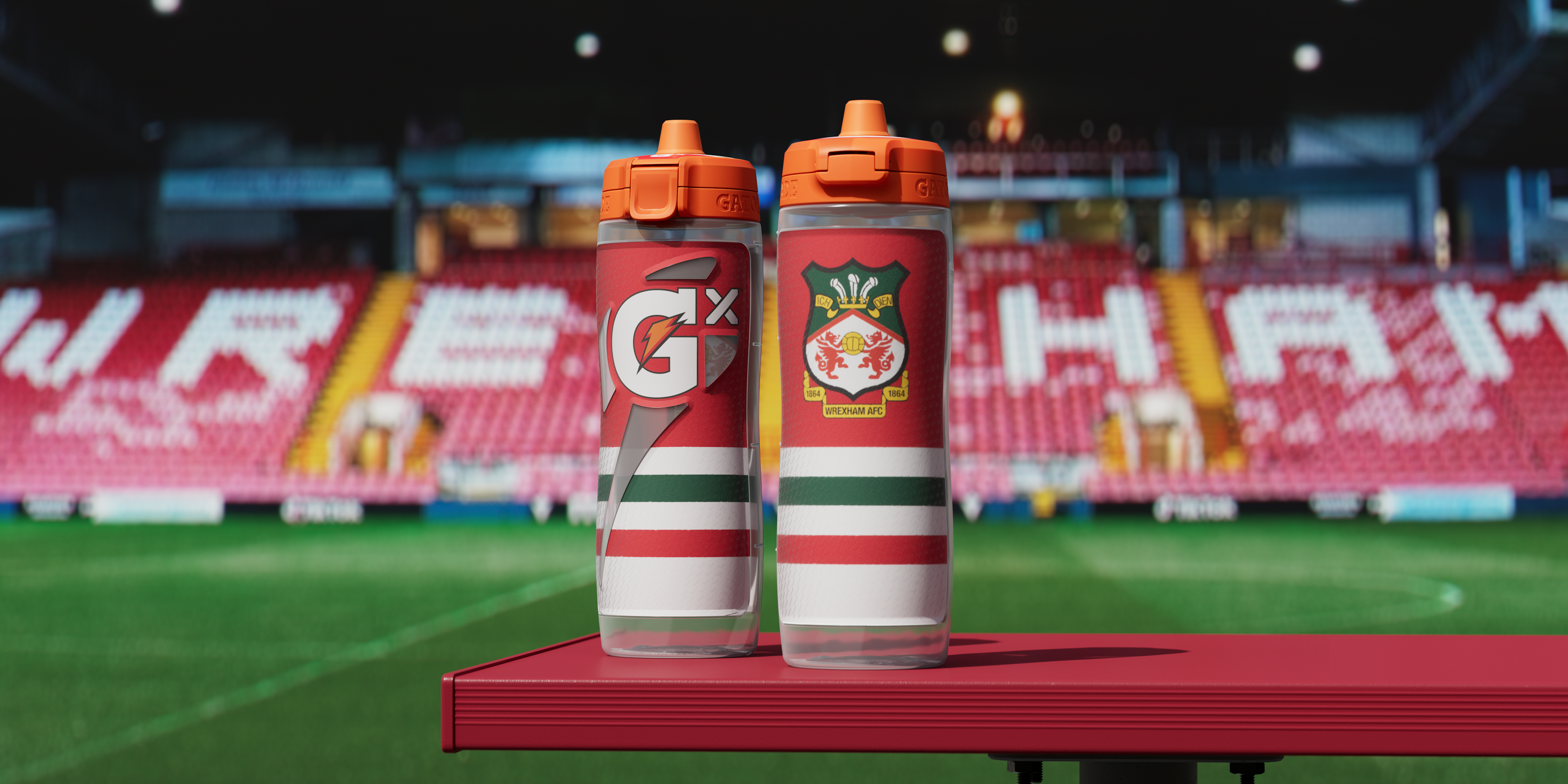 Wrexham bottles front and back on bench beside a field