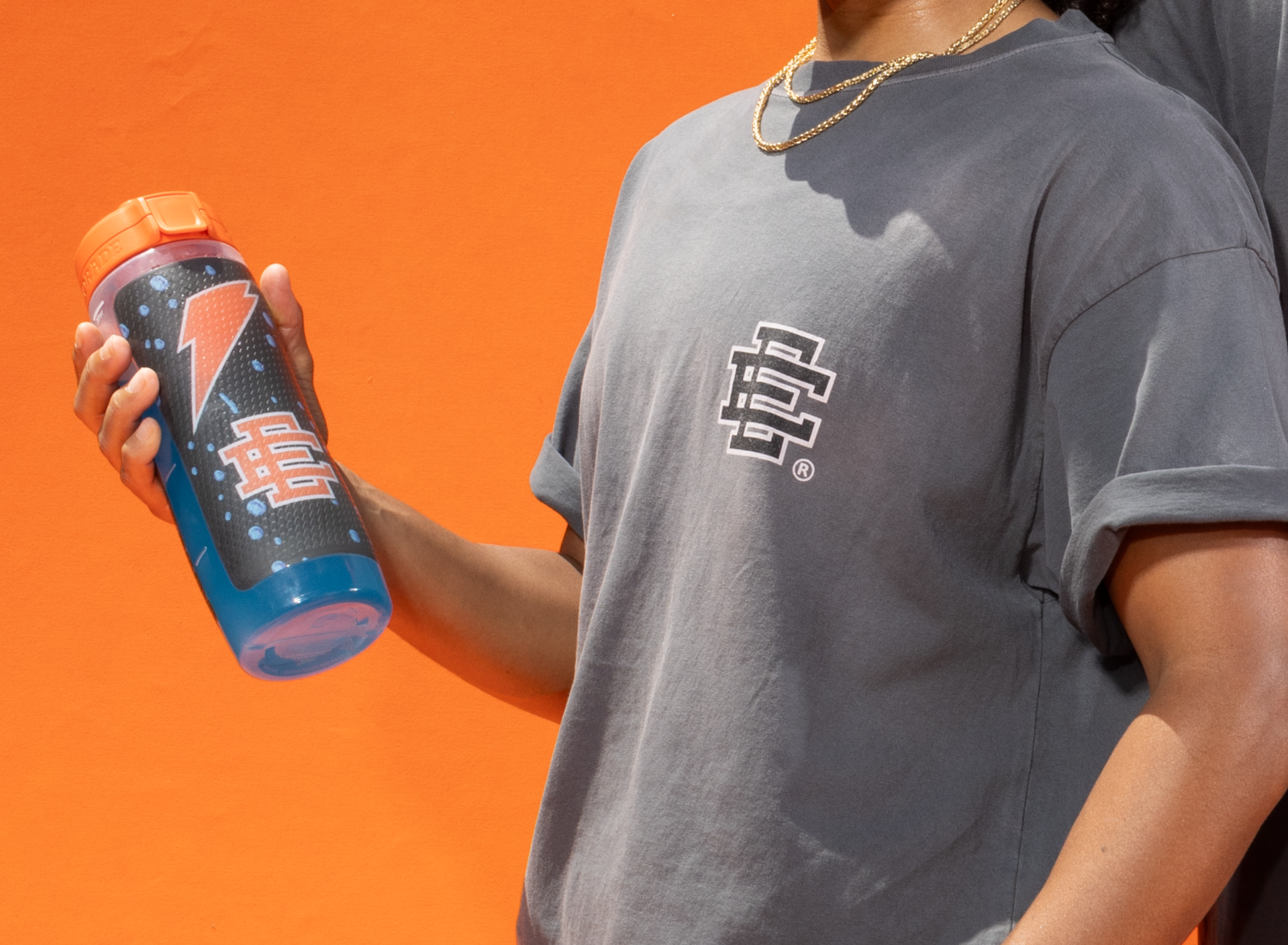 Model holding Eric Emanuel Bottle while wearing Gatorade Shirt