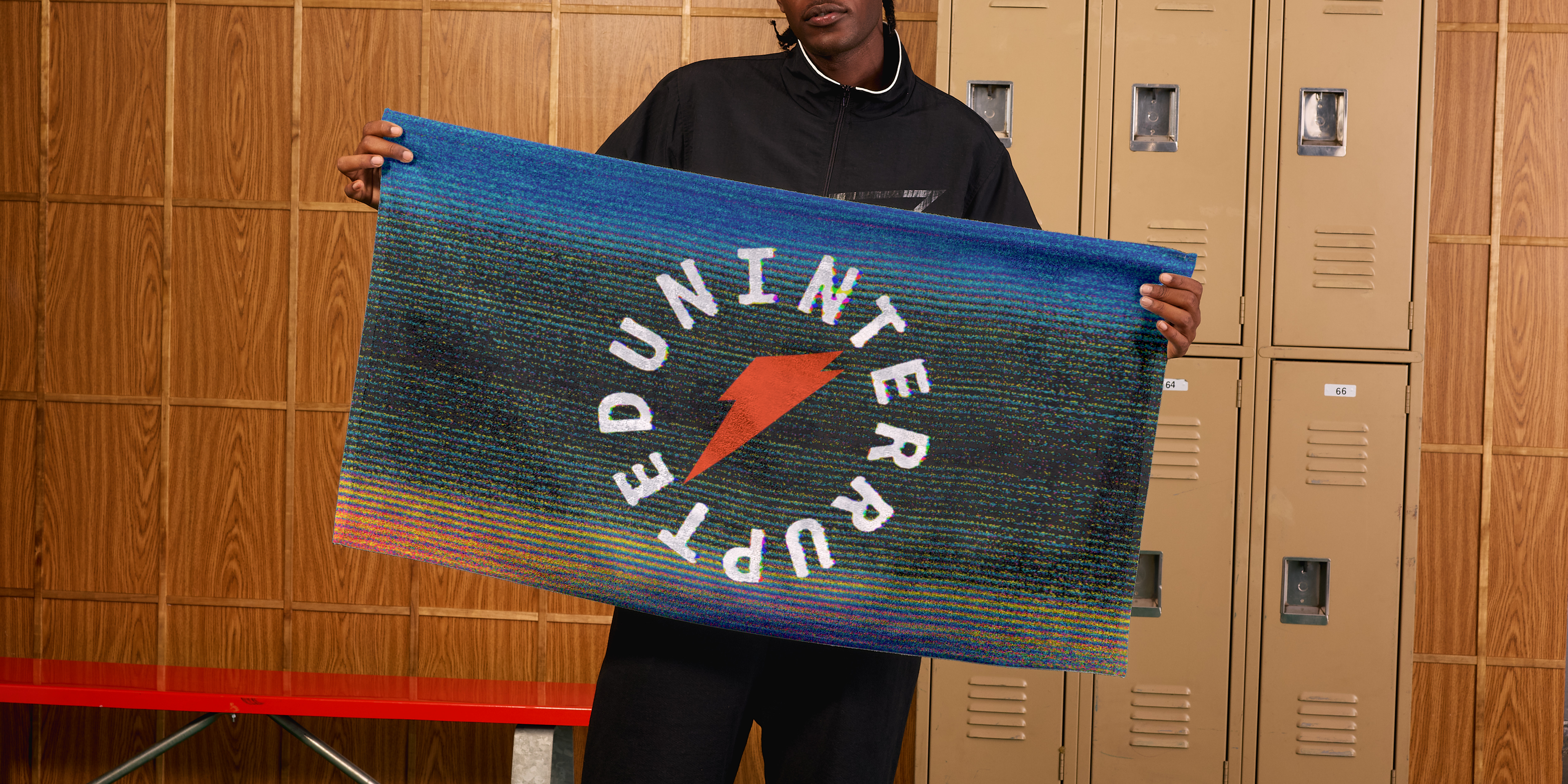 Man holding the Gatorade x UNINTERRUPTED Towel.