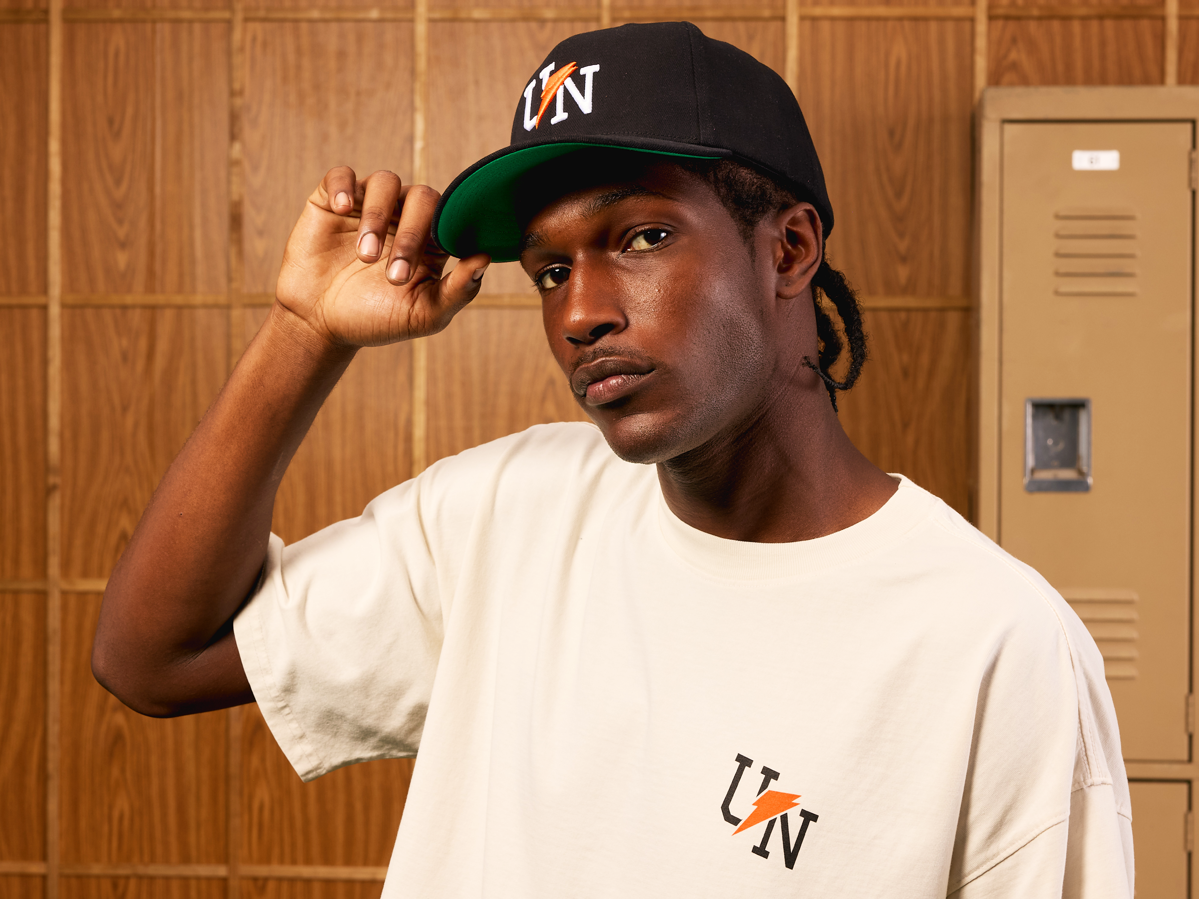 Man wearing the Gatorade x UNINTERRUPTED hat and t-shirt, doing a hat-tip.