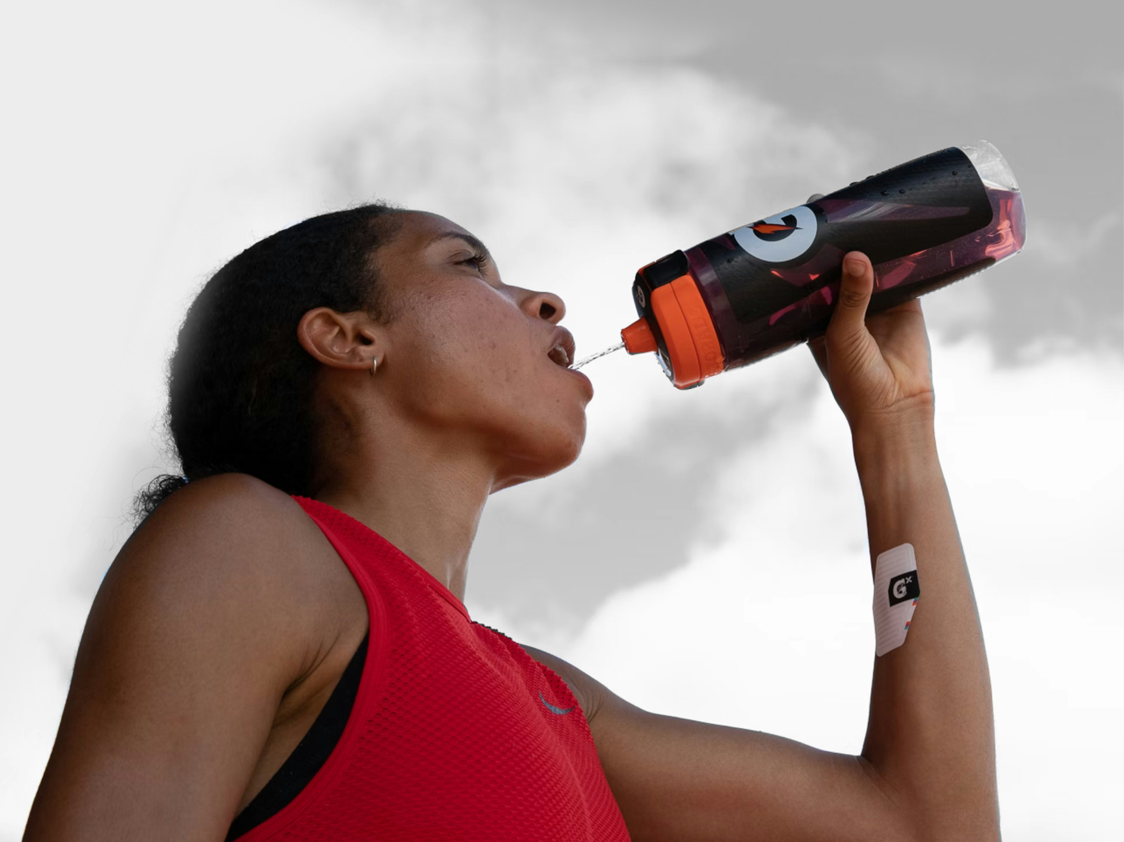 Athlete drinking Gatorade with Gx sweat patch