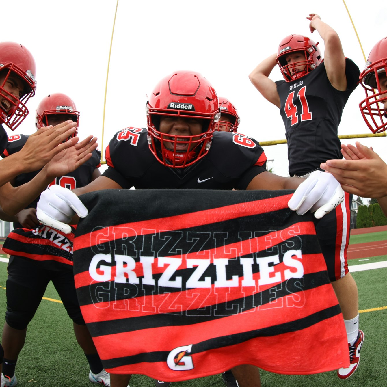 Football player holding Grizzlies custom towel