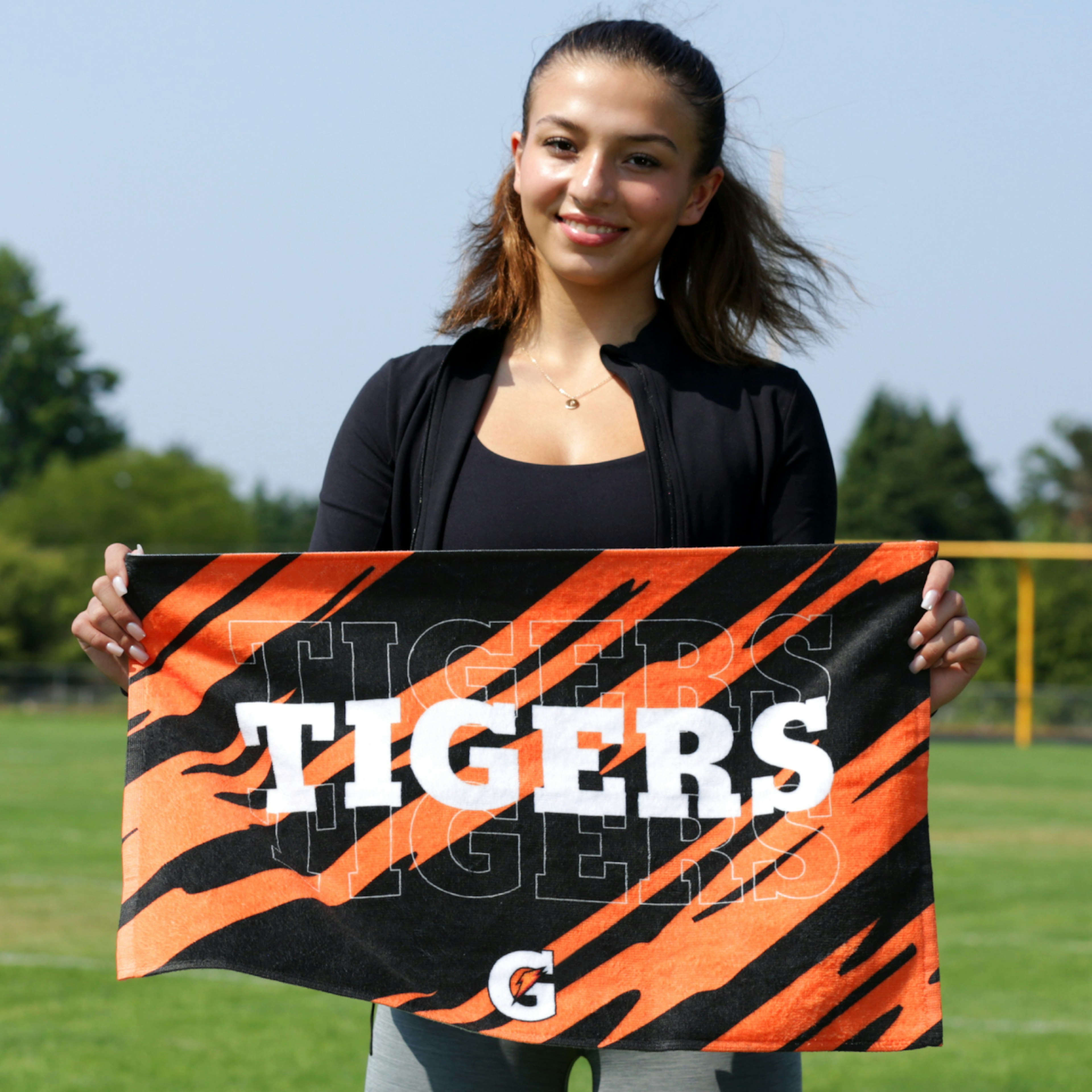 Teen holding Tigers custom towel