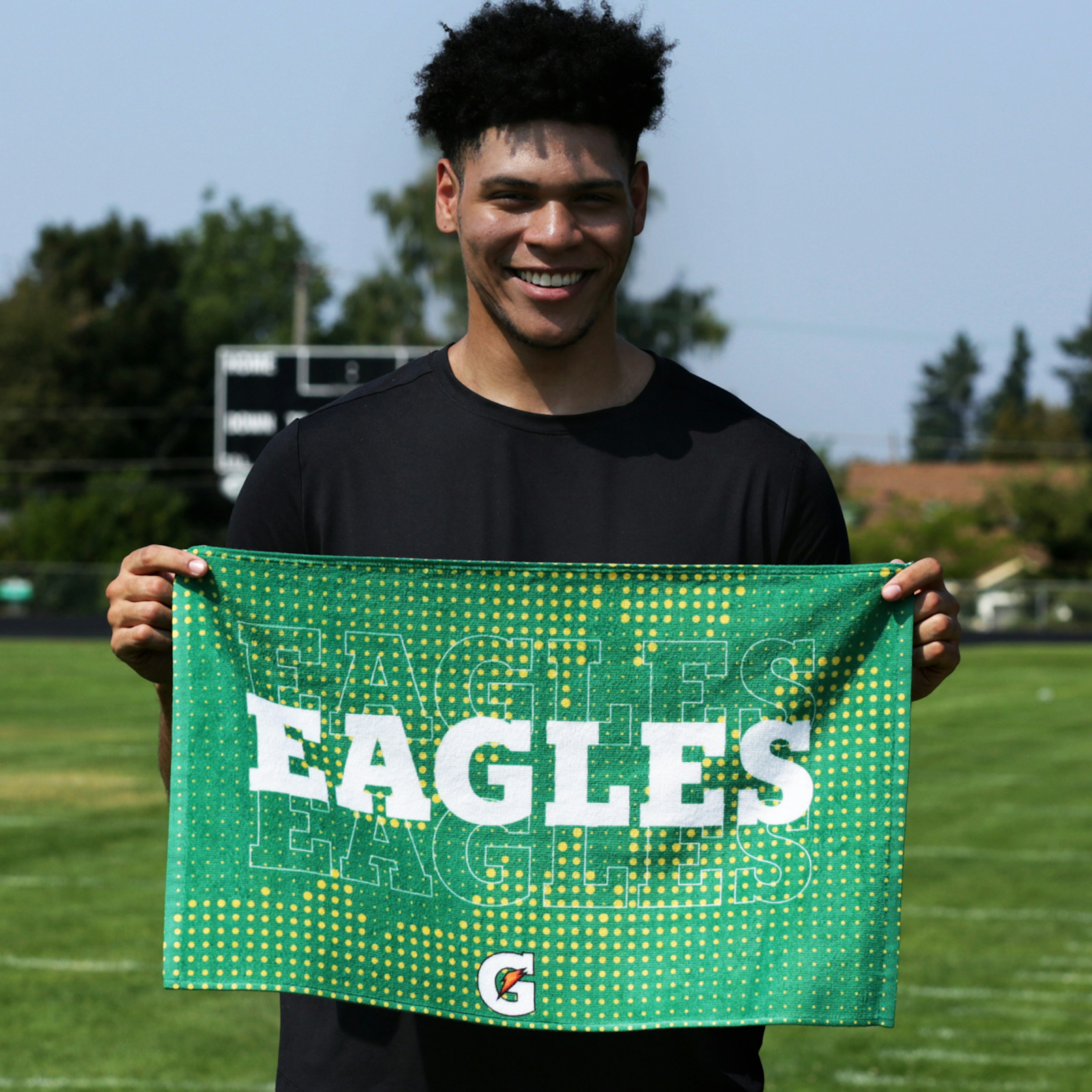 Teen holding Eagles custom towel