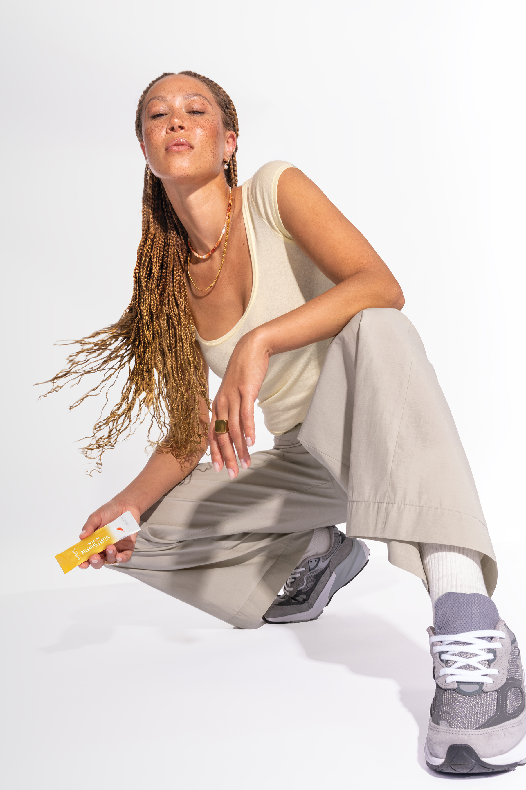 Woman sitting and holding tropical mango hydration booster