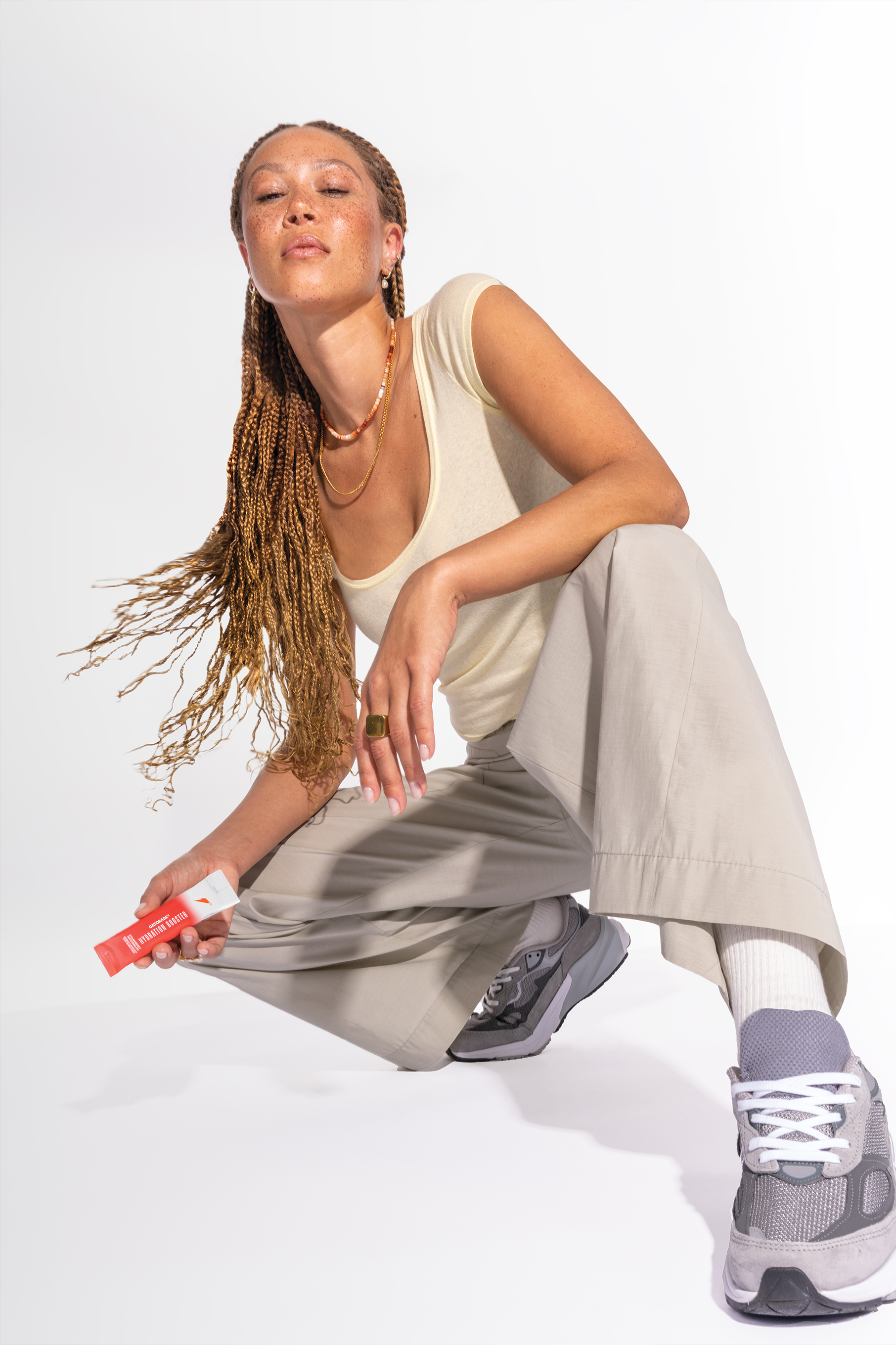 Woman sitting and holding strawberry watermelon hydration booster