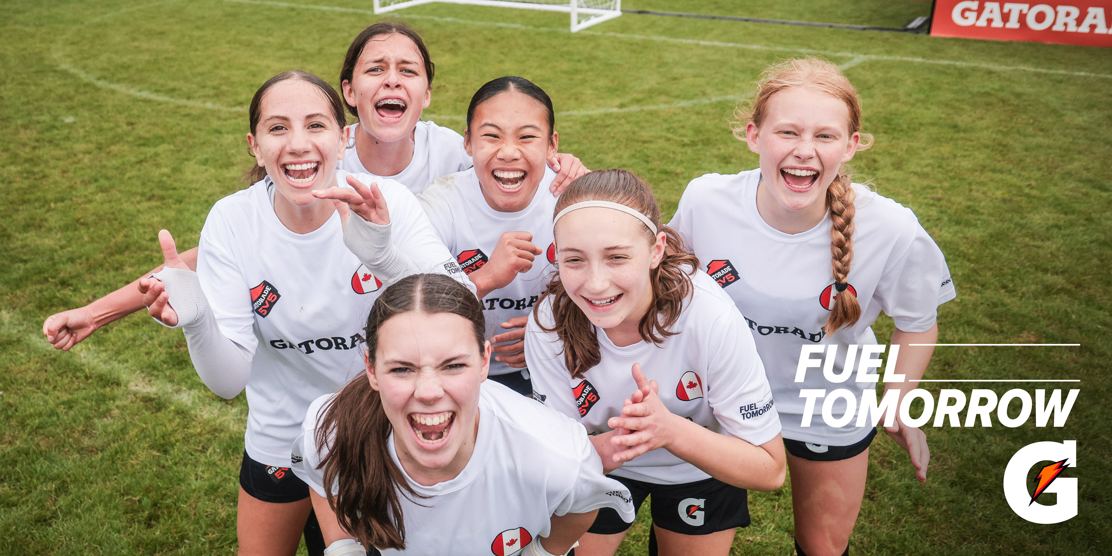 Girls in soccer uniforms laughing and smiling for the camera, with an overlaid "Fuel Tomorrow" and Gatorade logo
