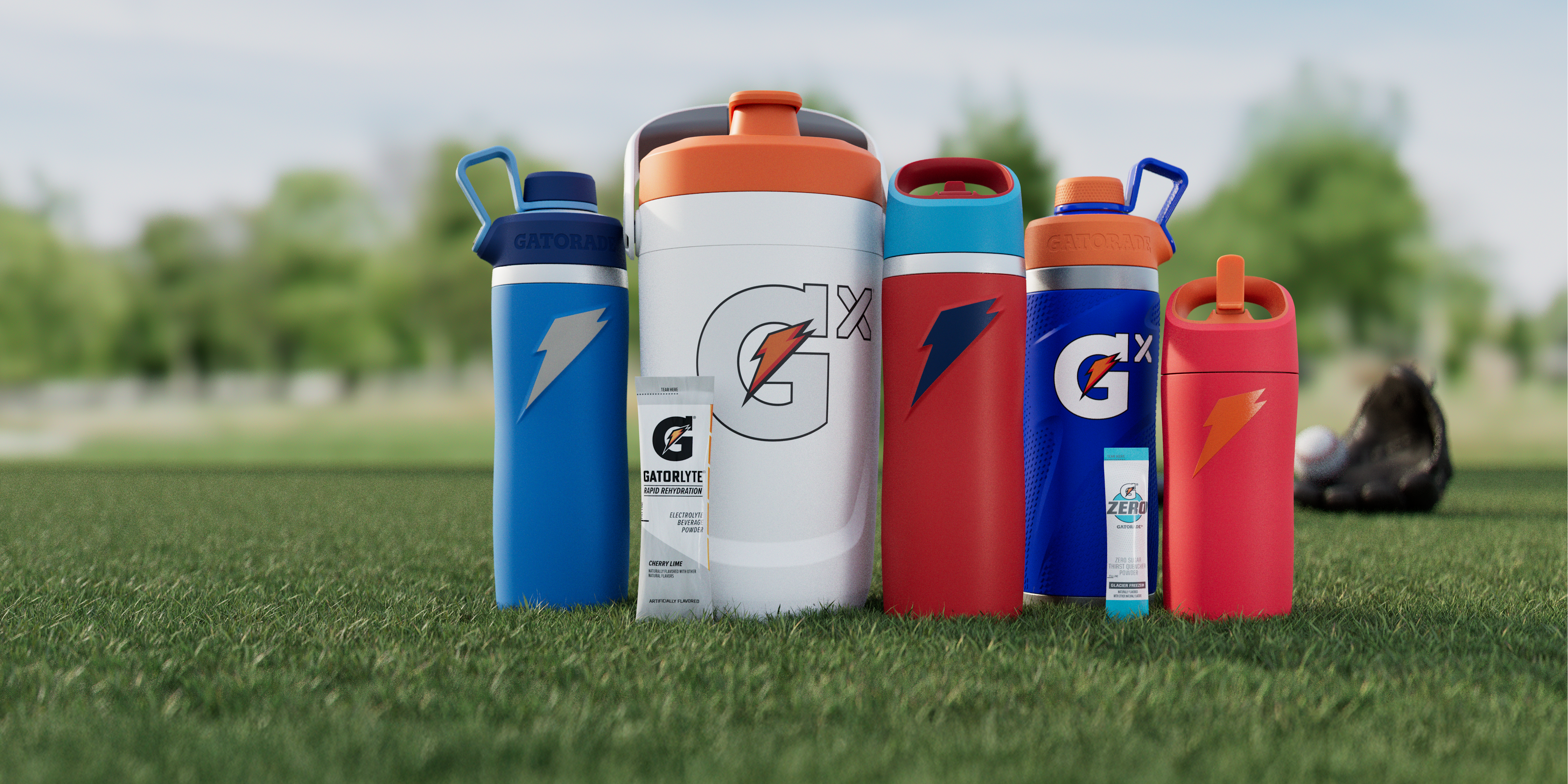 memorial day image of blue , white and red bottles on a field. overtime bottle, gx jug, gx stainless steel and rookie bottle