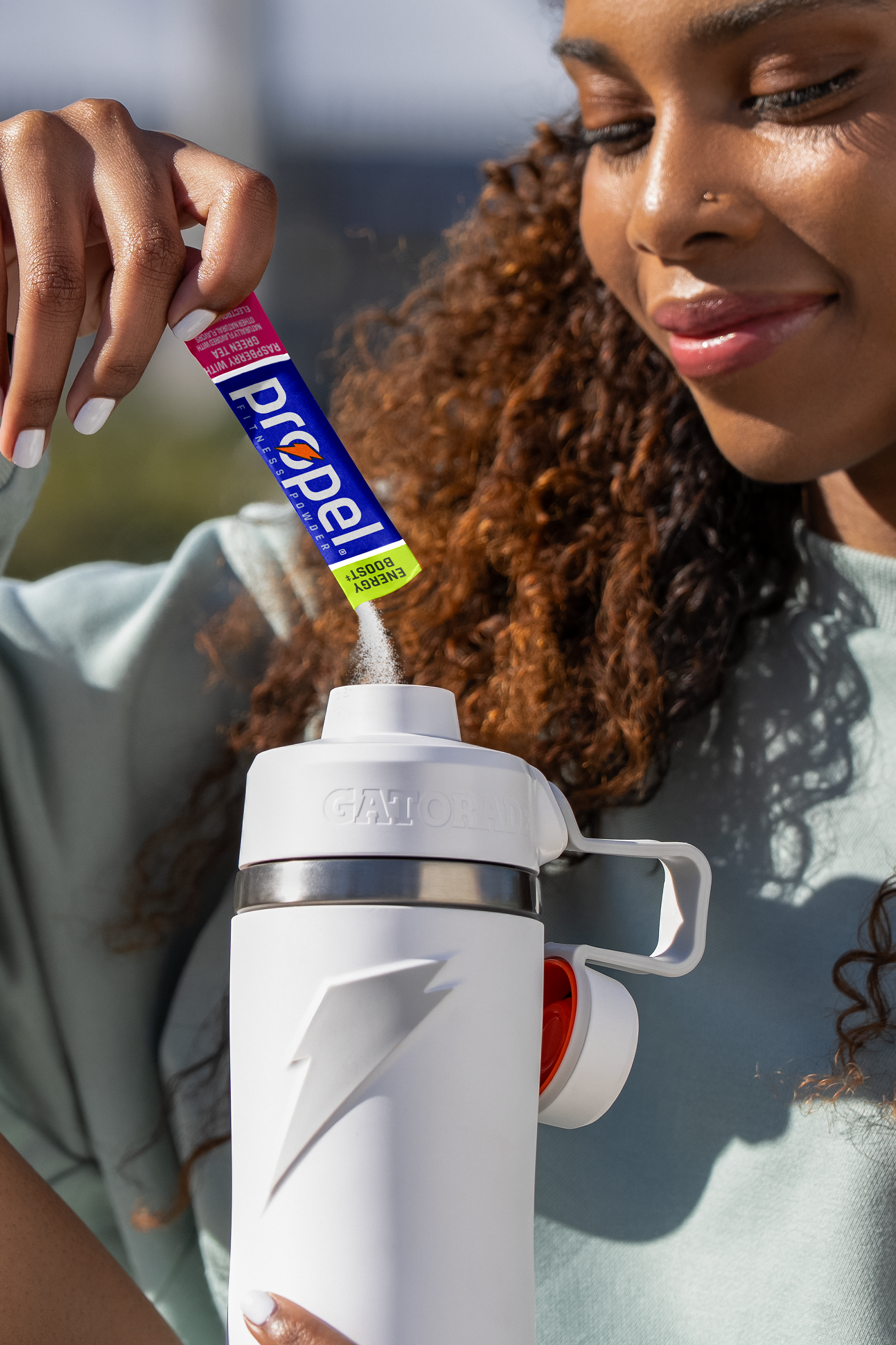 Propel energy boost powder being poured into overtime bottle
