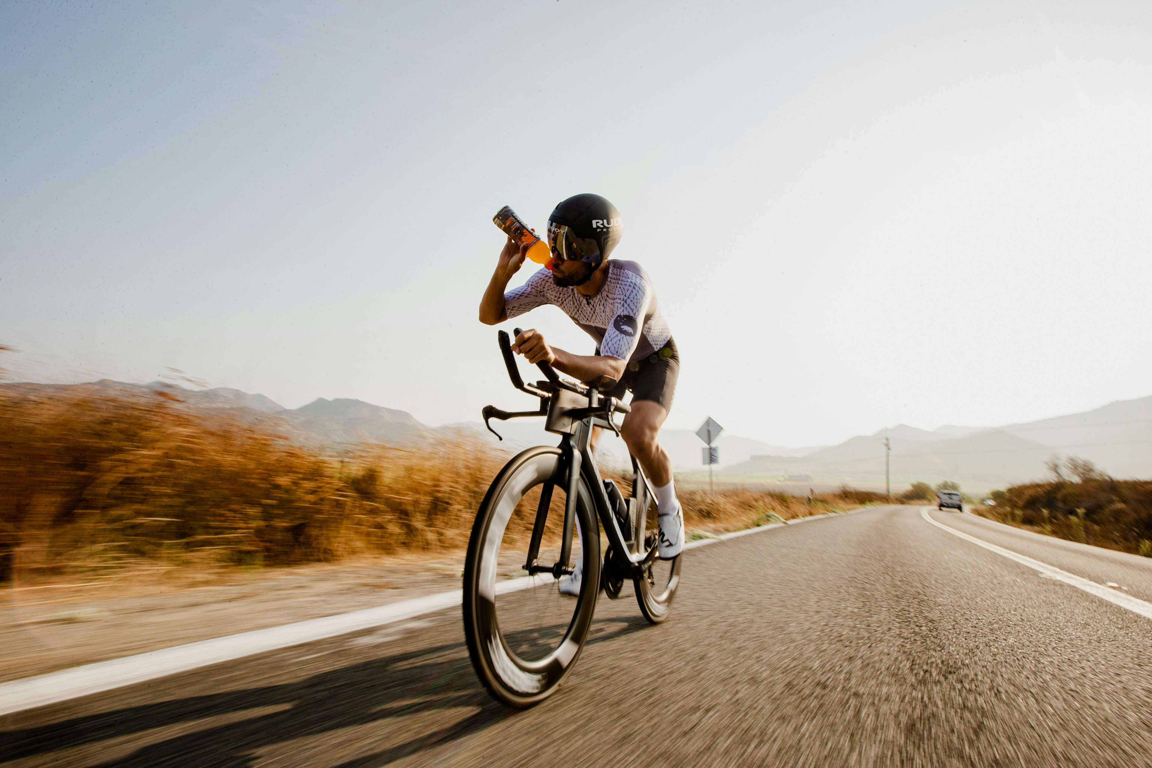 man biking and drinking gatorade