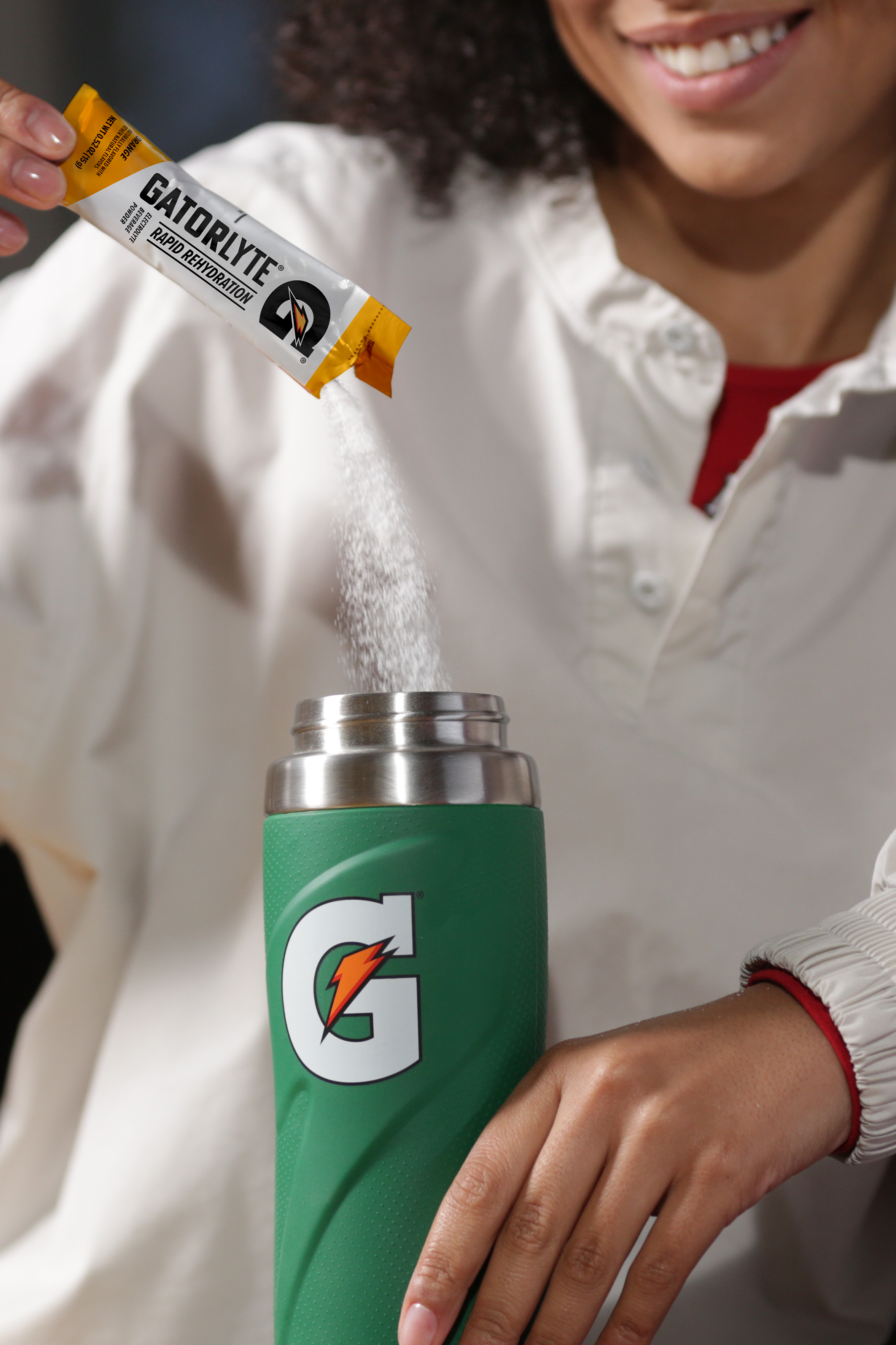 Gatorlyte being poured into g stainless bottle