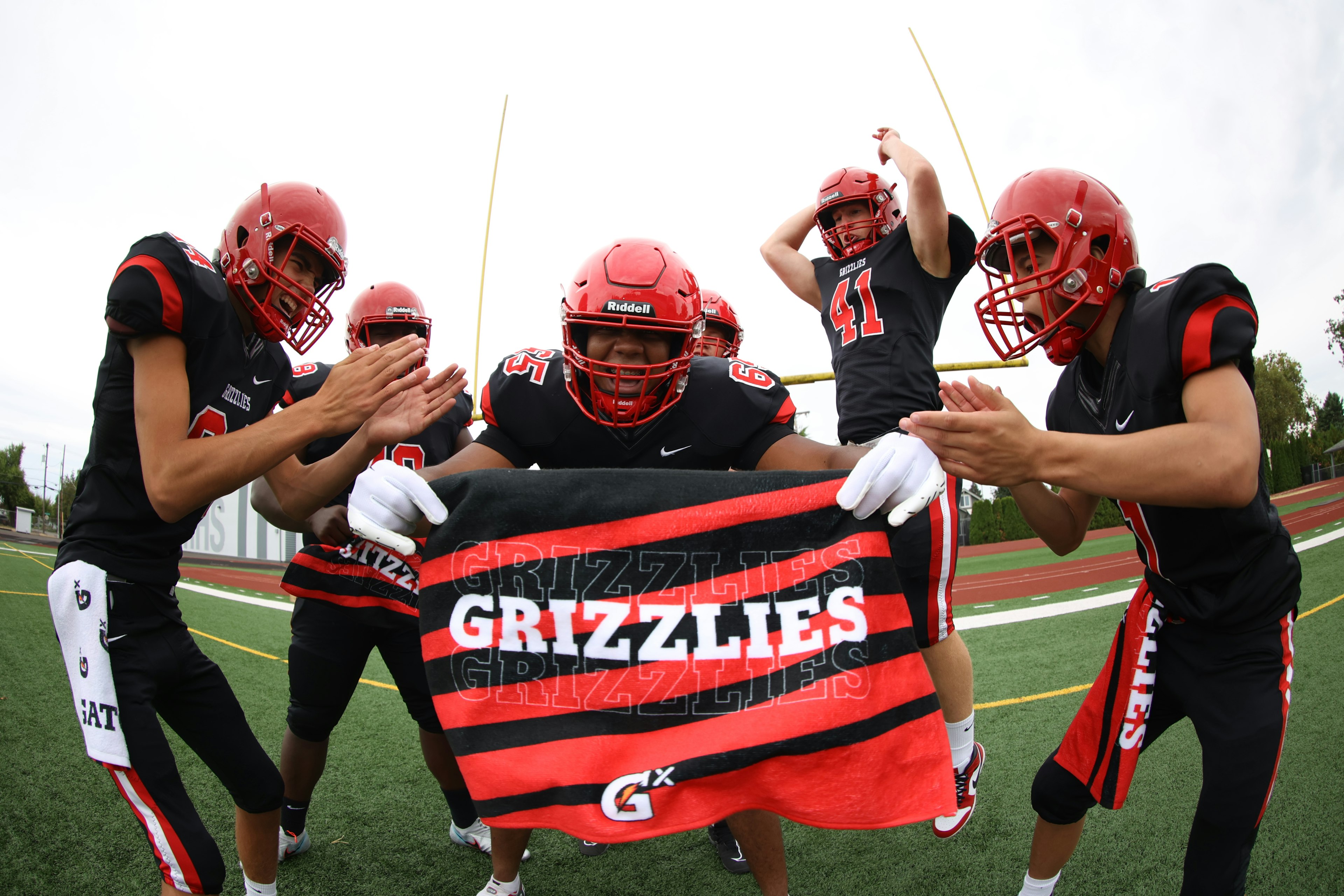 football players holding a towel