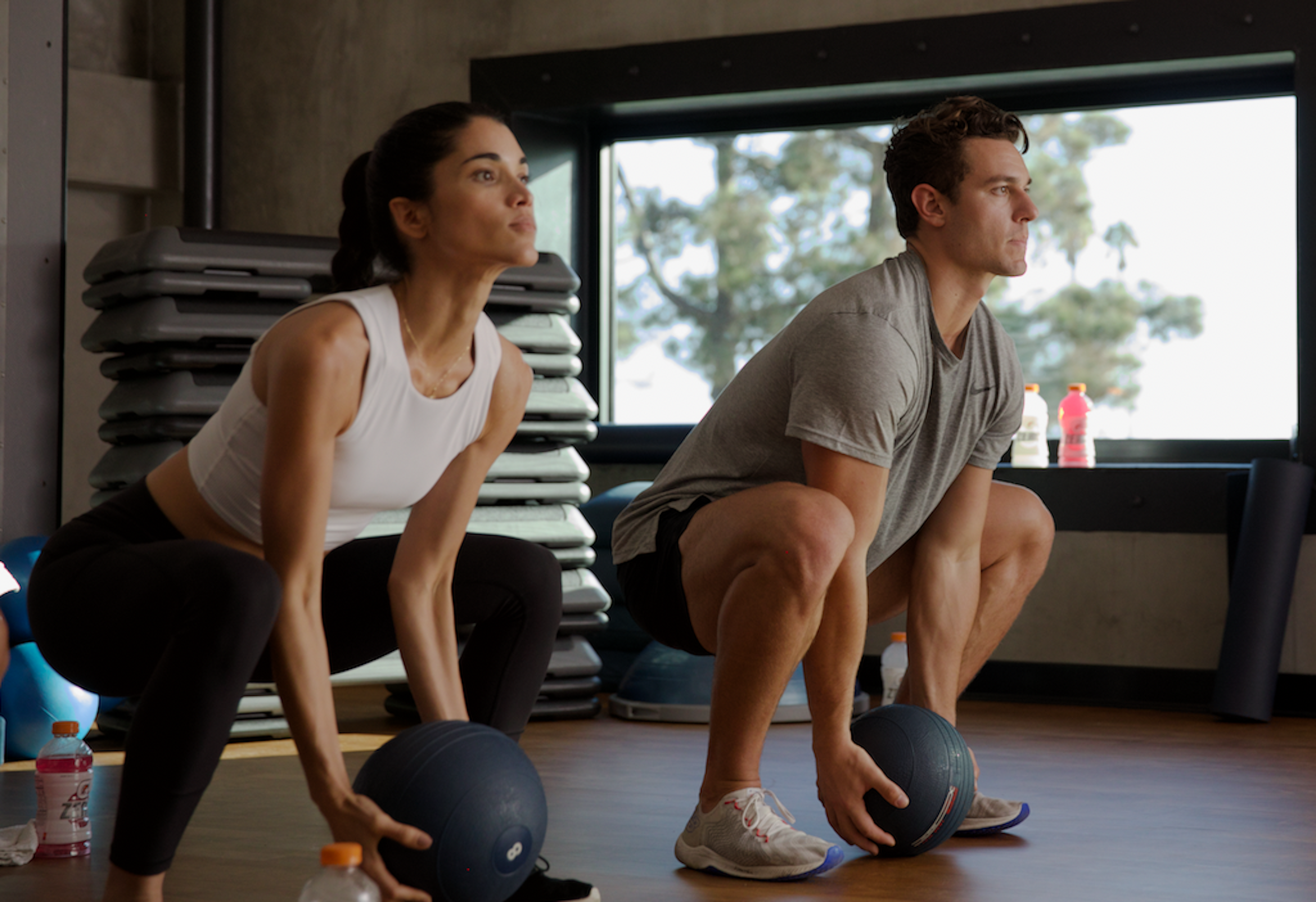 man and woman working out with medicine ball