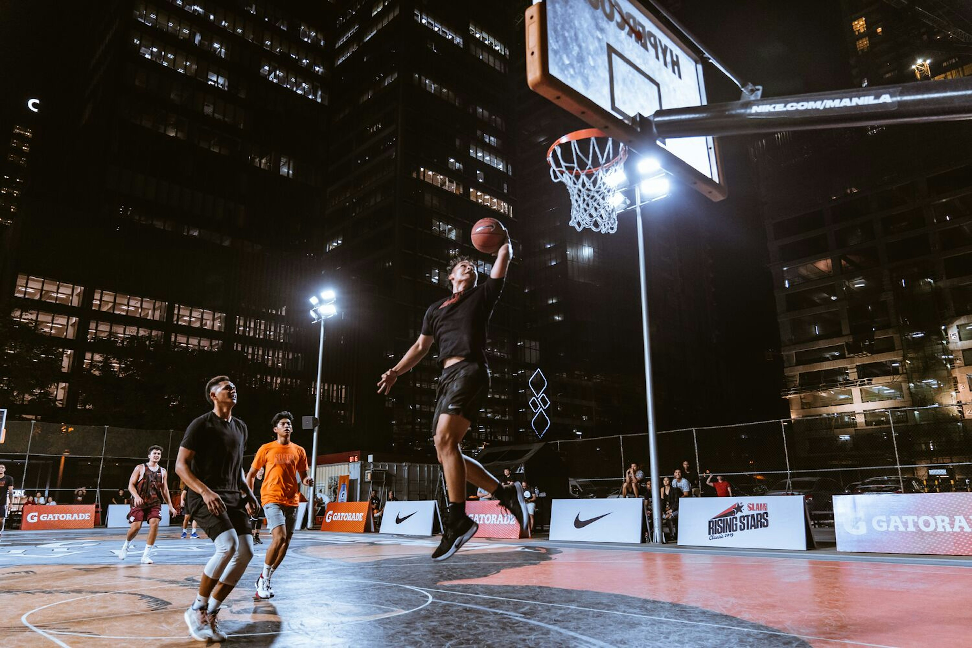 men playing basketball at night