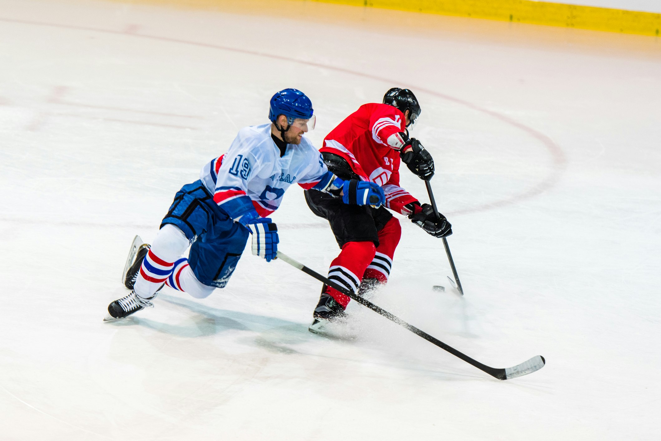 two hockey players fighting for puck