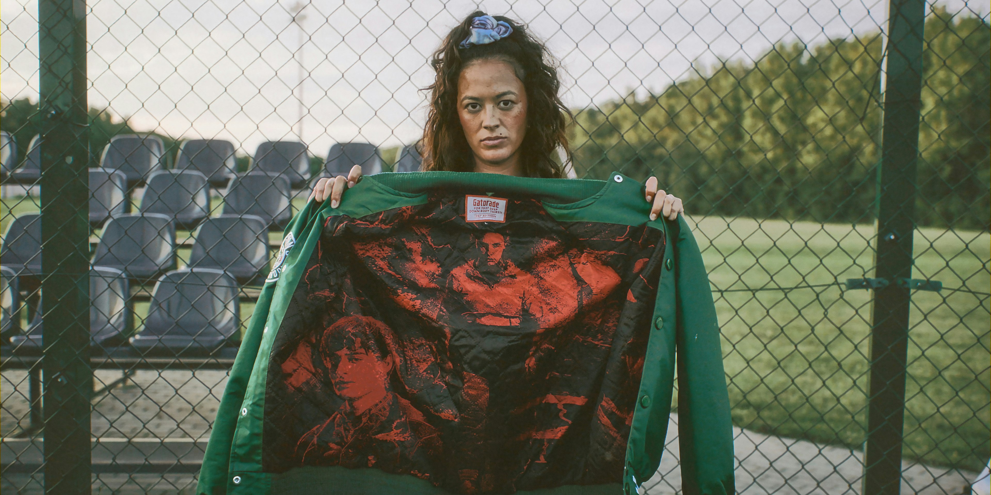 stranger things jacket with woman on field