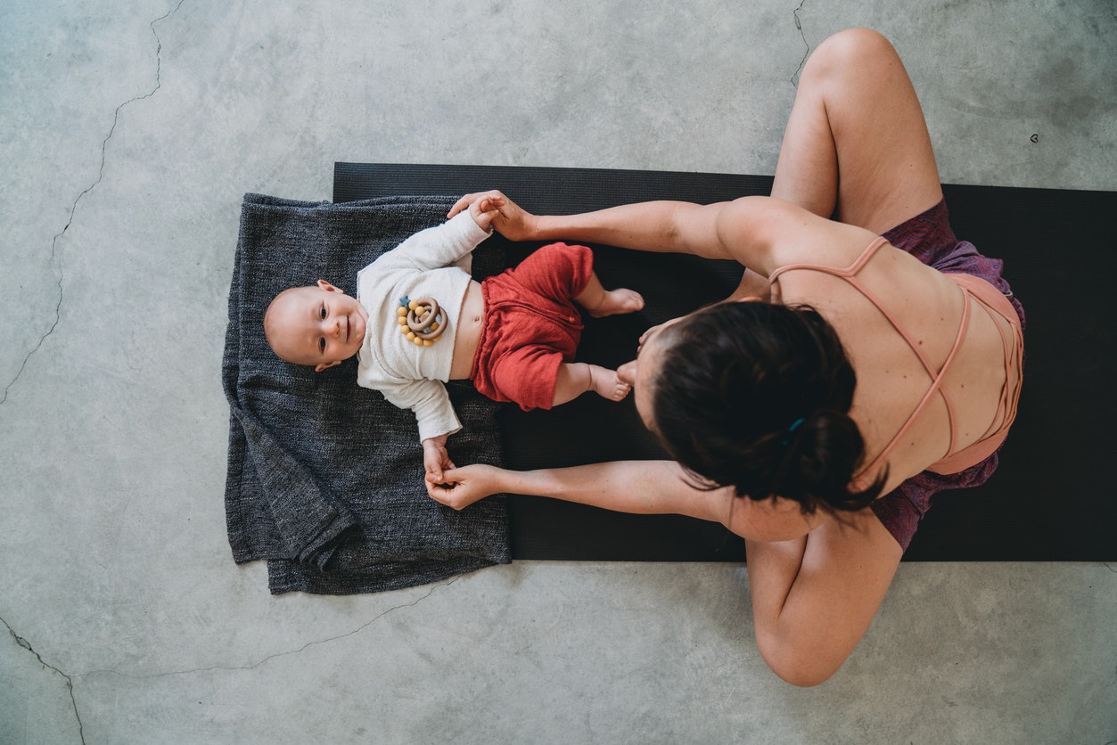woman exercising with baby