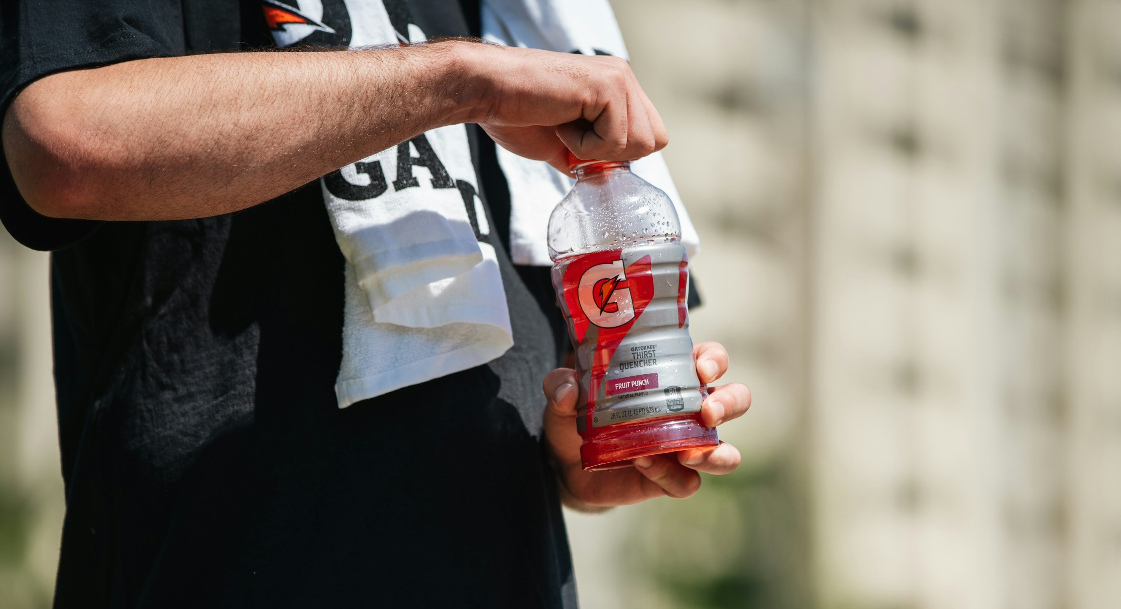 man opening gatorade bottle
