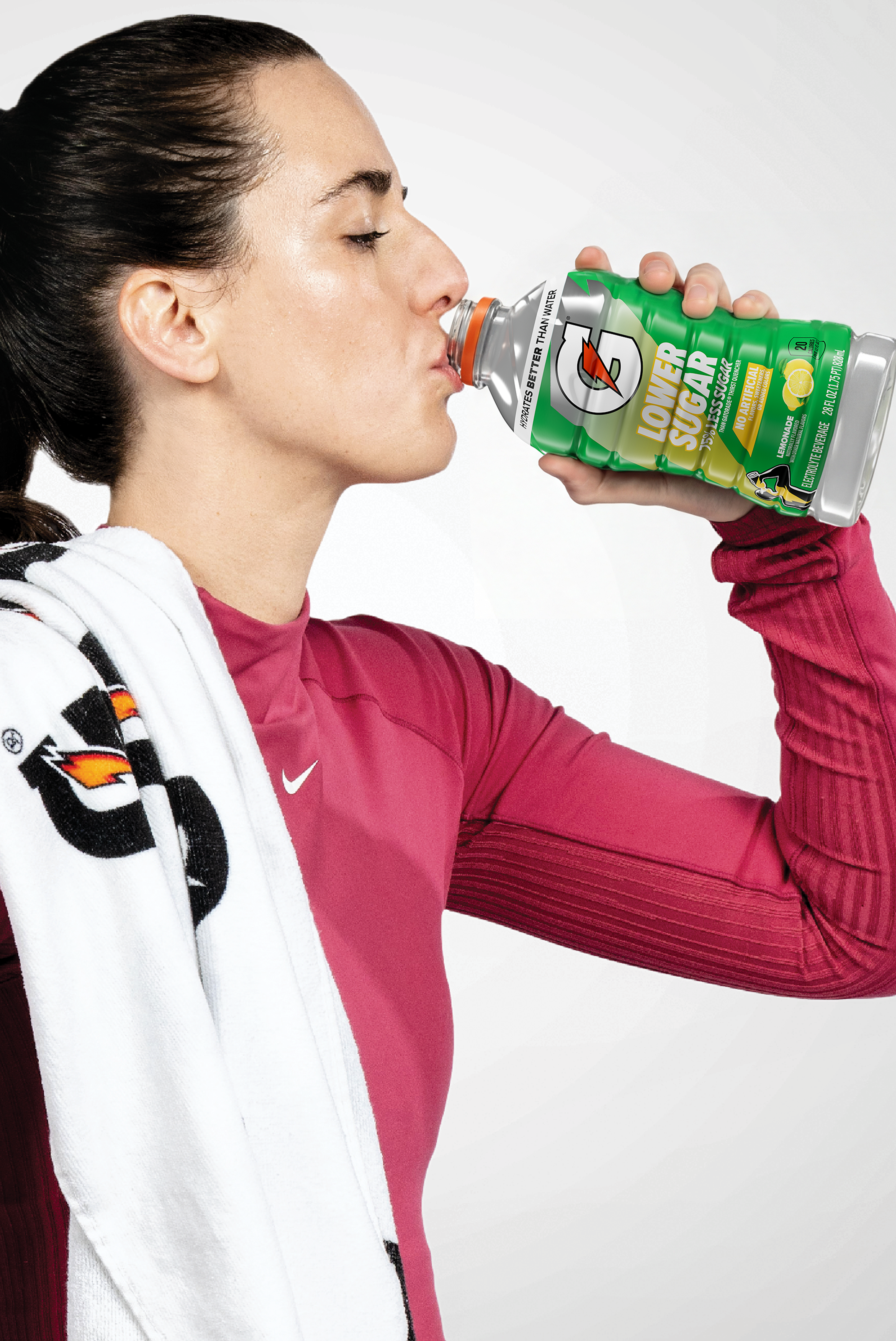 caitlin clark drinking from a 28fl oz bottle of Gatorade Lower Sugar Lemonade