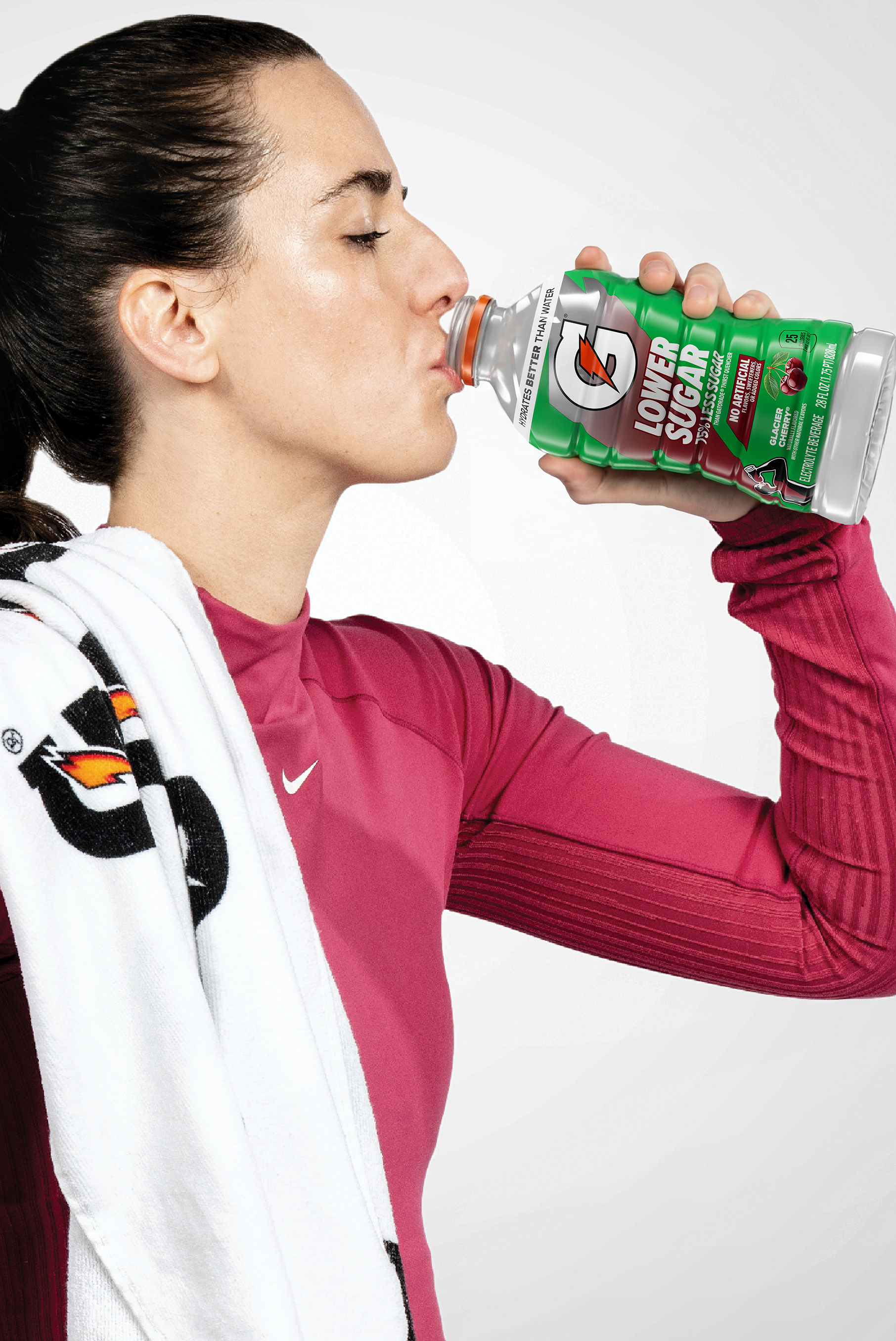 caitlin clark drinking from a 28fl oz bottle of Gatorade Lower Sugar Glacier Cherry