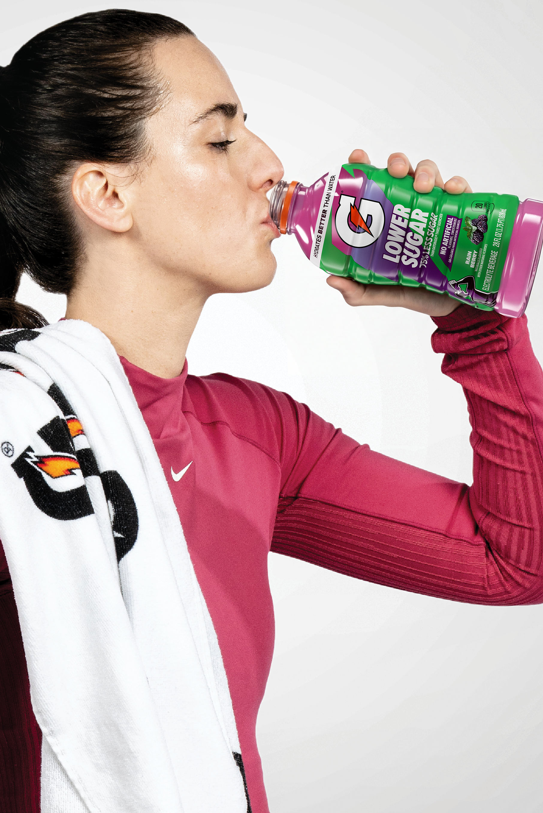 caitlin clark drinking from a 28fl oz bottle of Gatorade Lower Sugar Rain Berry