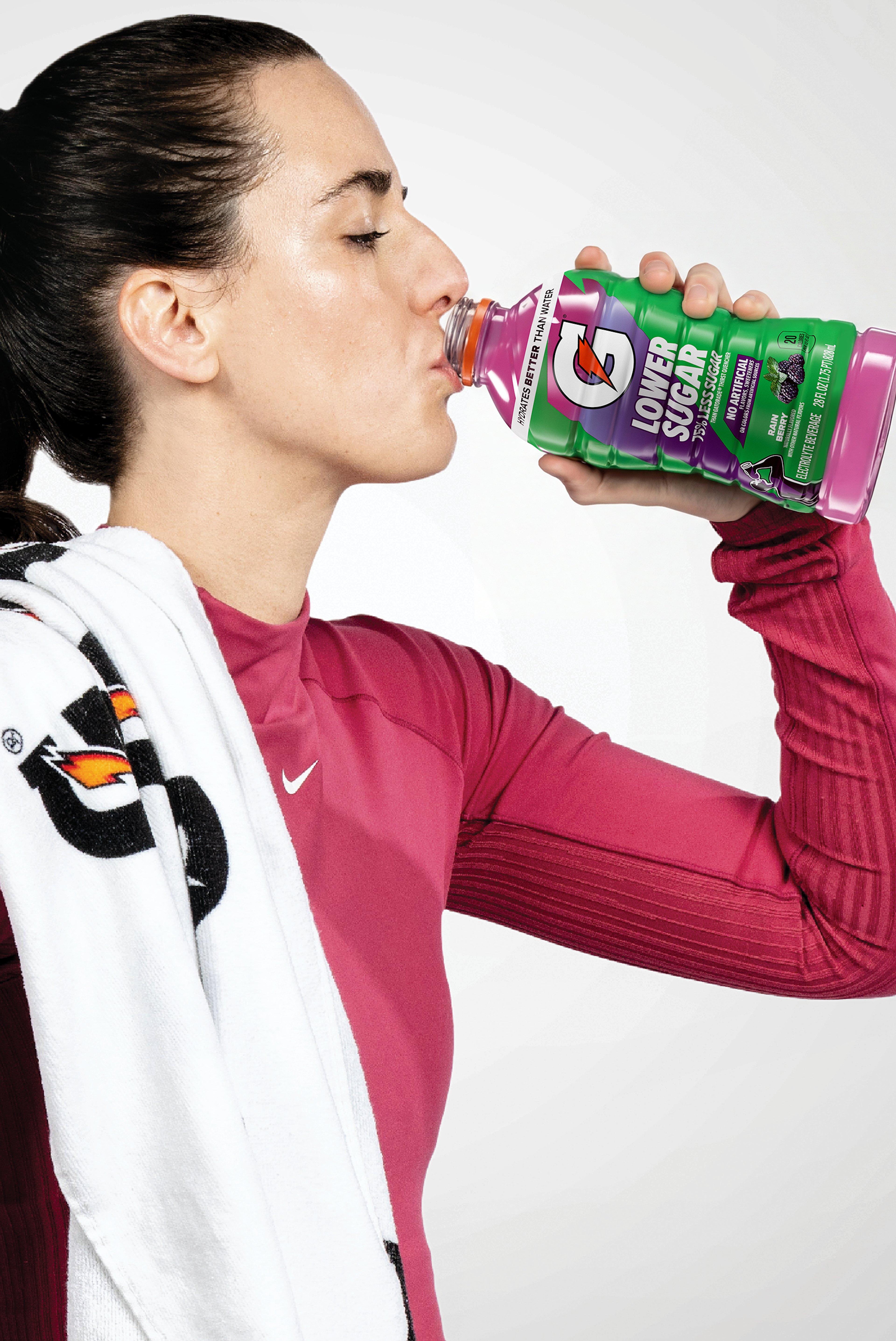 caitlin clark drinking from a 28fl oz bottle of Gatorade Lower Sugar Rain Berry