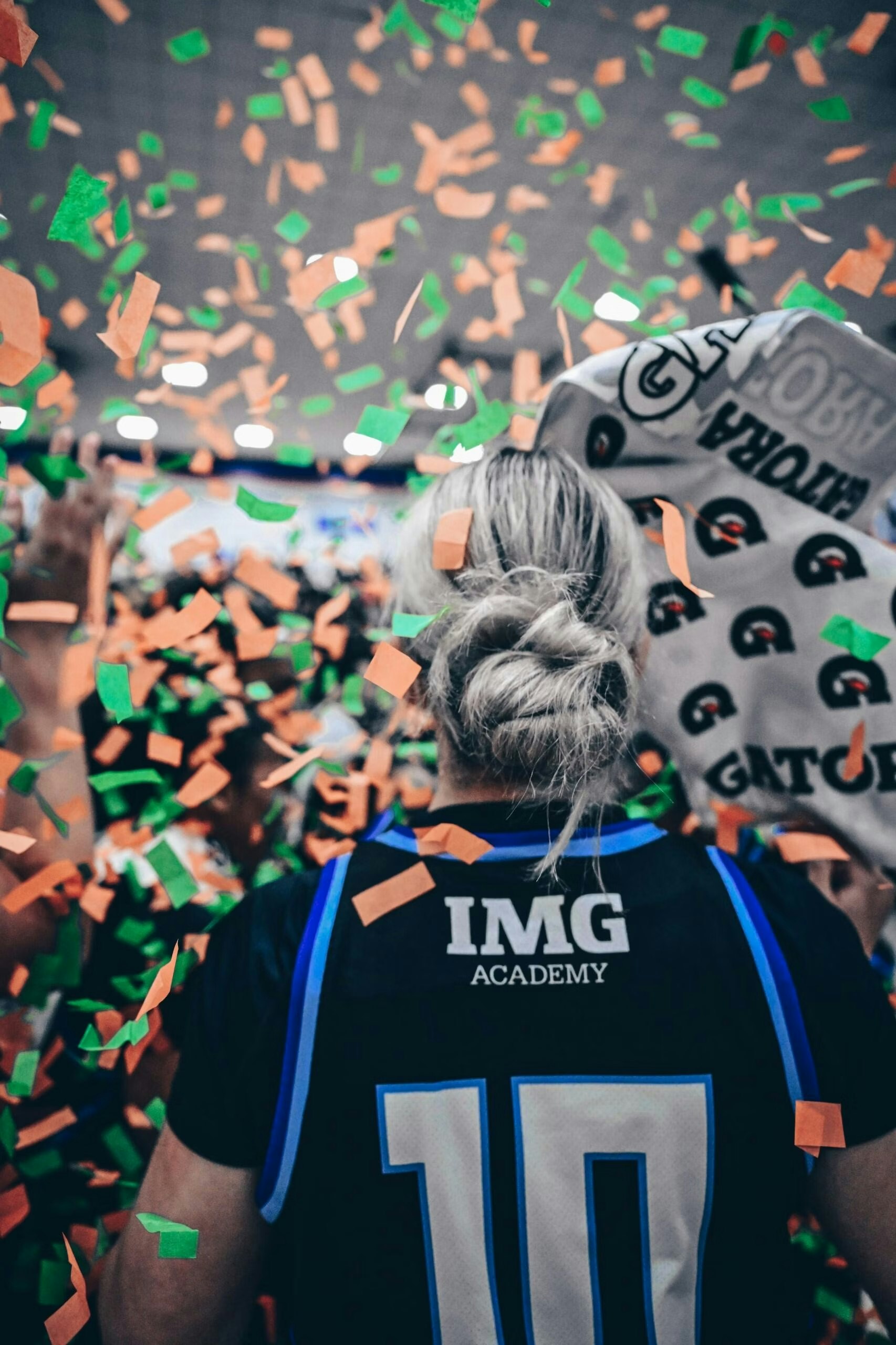back of img academy athlete celebrating with confetti
