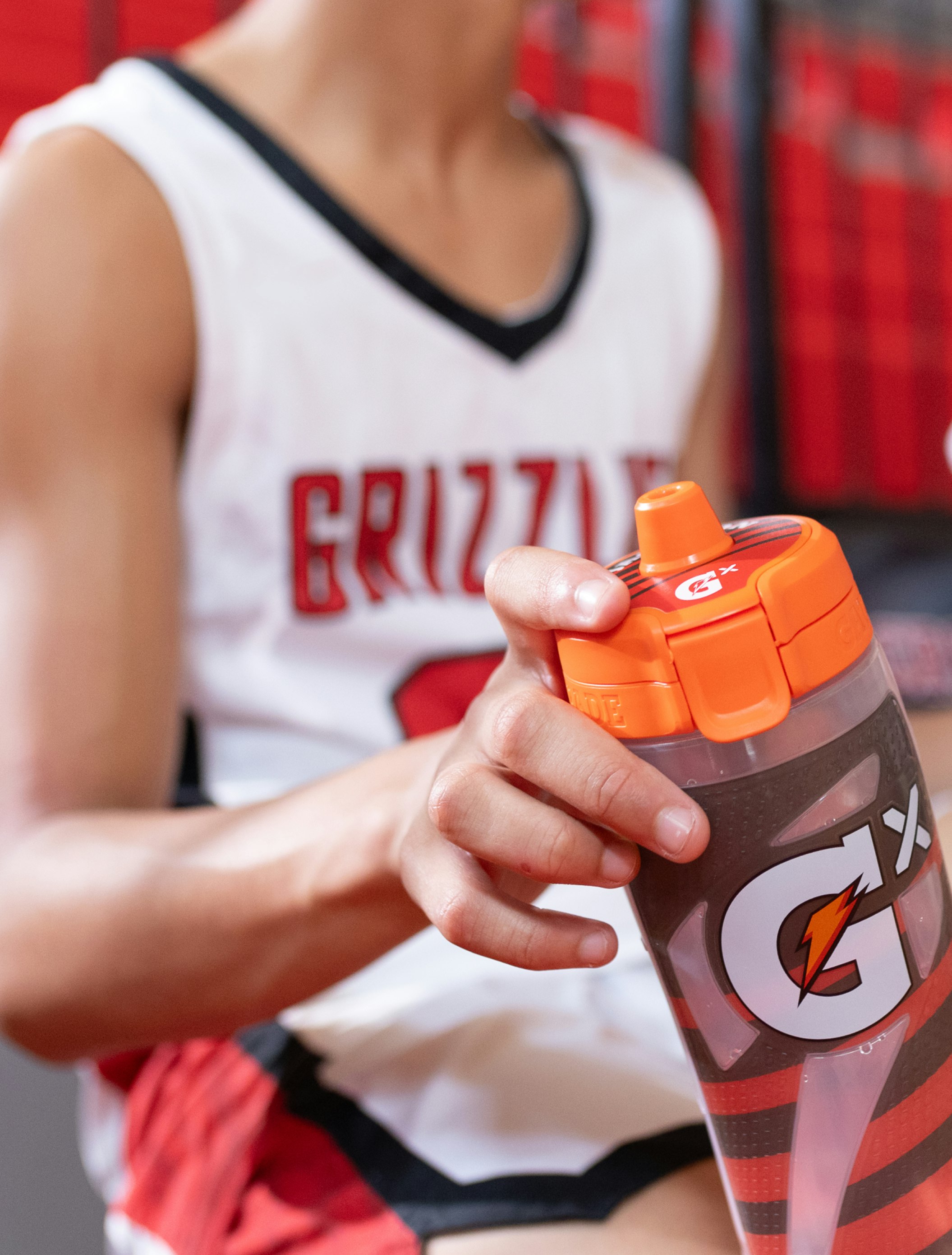 basketball player holding gatorade squeeze bottle