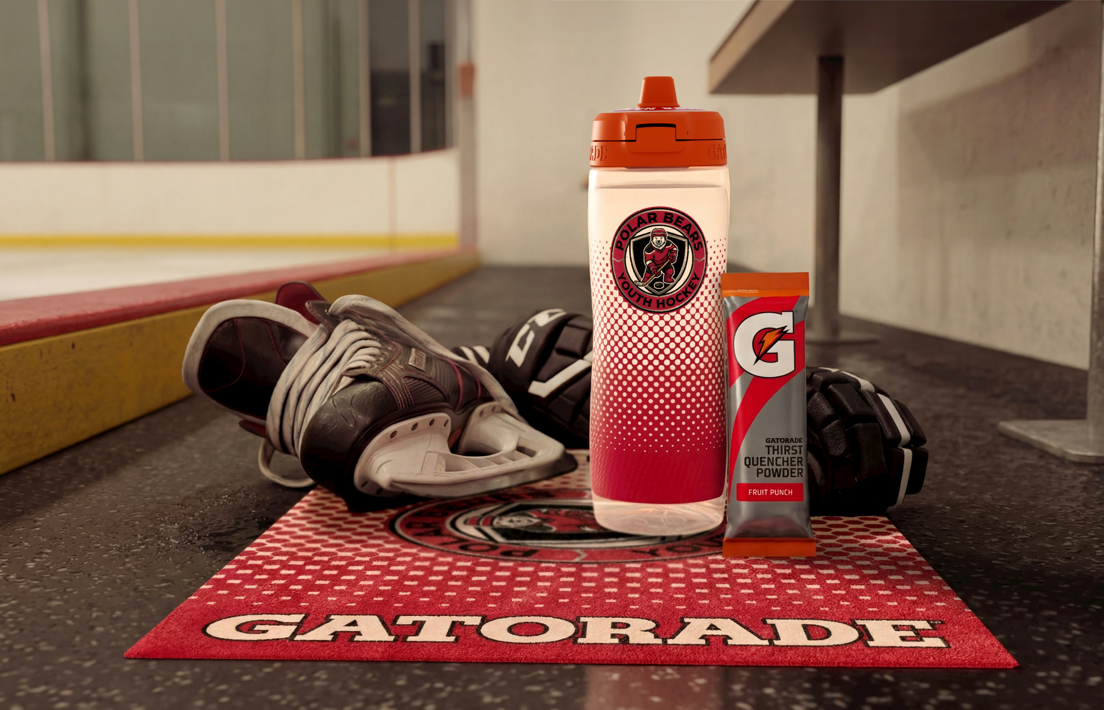 Gatorade squeeze bottle, towel and powder next to ice skating rink