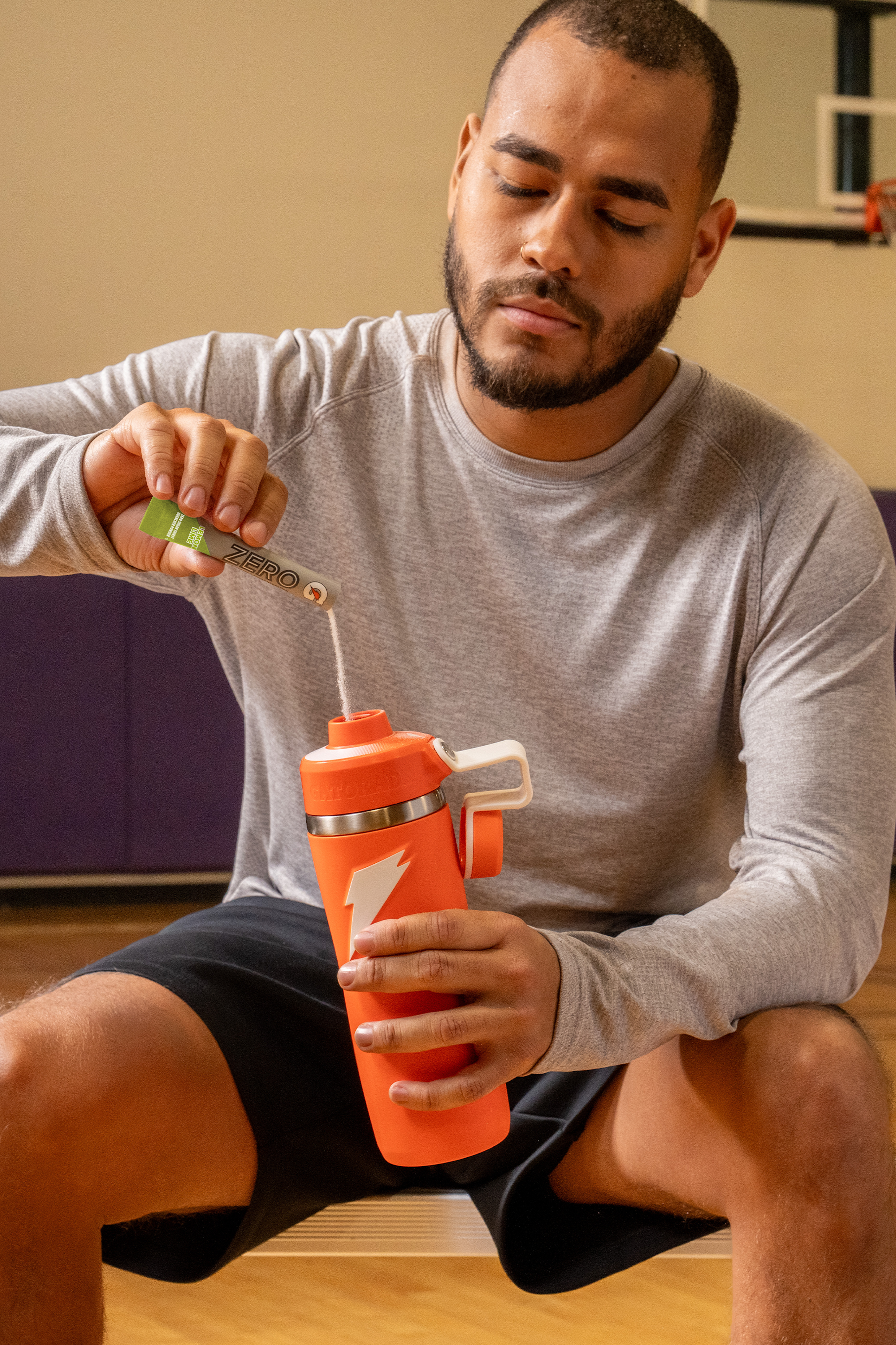 Gatorade Zero powder single serve lemon lime being poured into overtime bottle